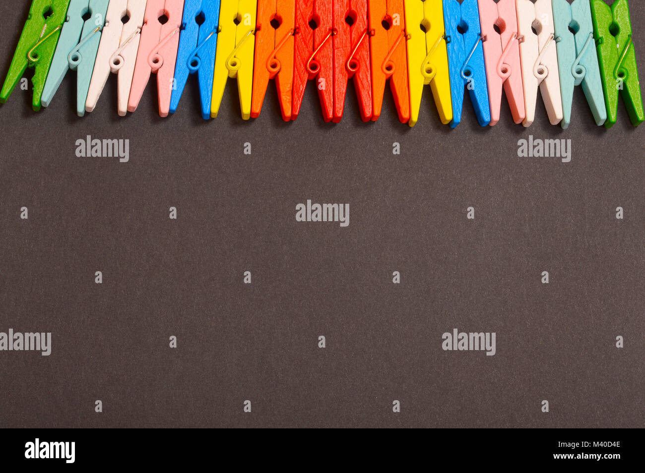 Colorful clothespins on black background Stock Photo