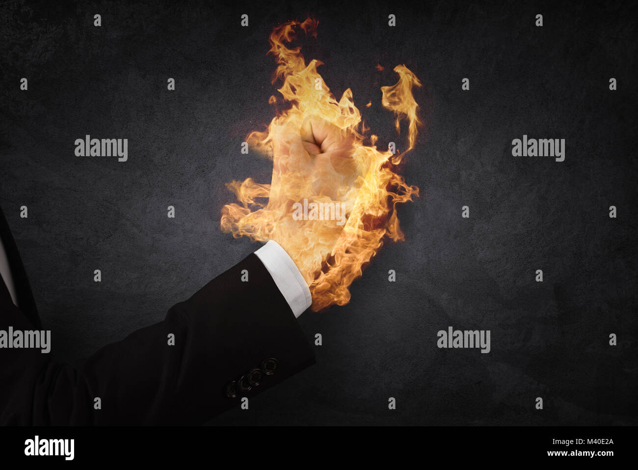 Close up of businessman hand holding fire in fist. Stock Photo