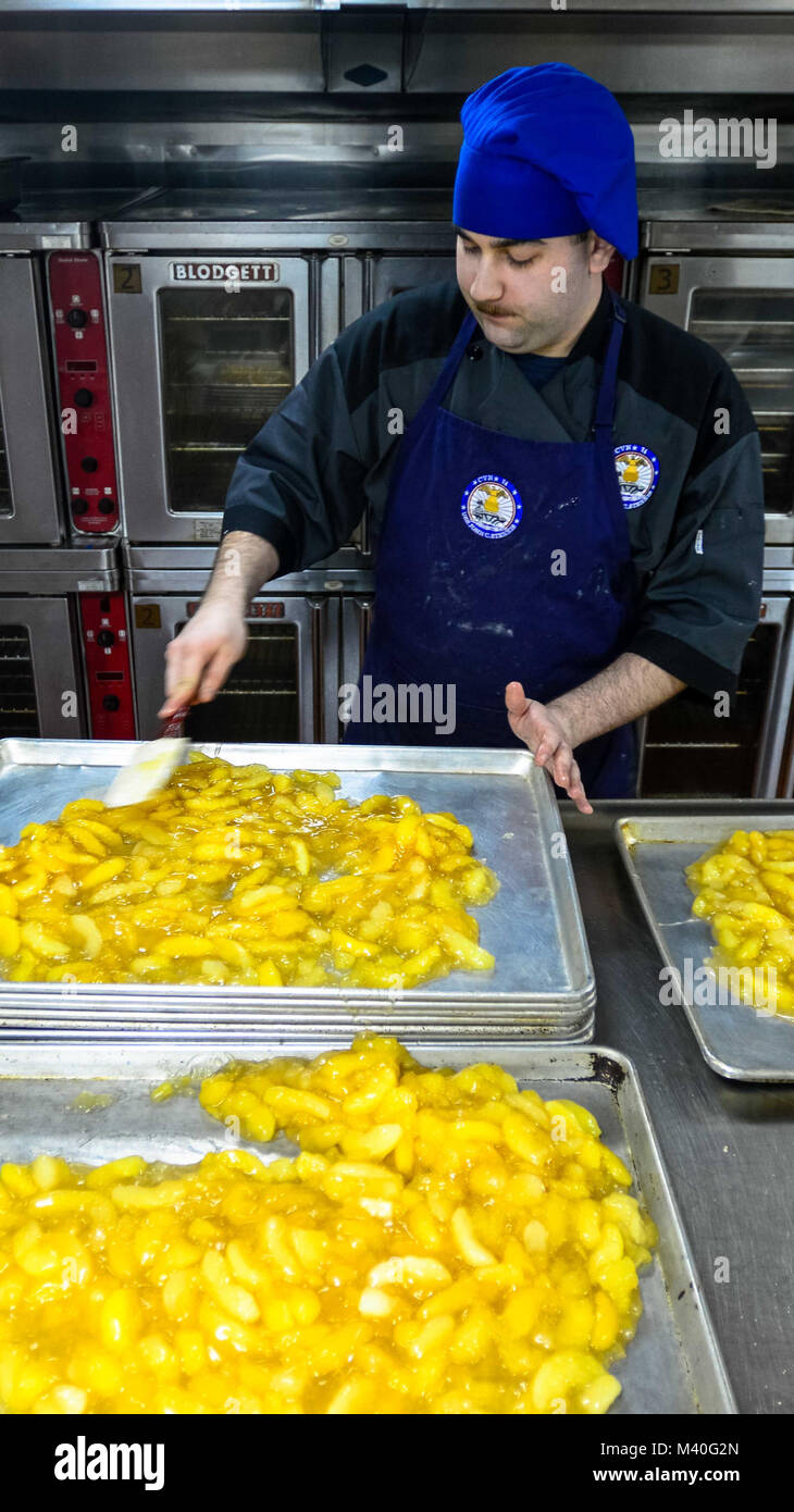150127-N-TC437-027 PACIFIC OCEAN (Jan. 27, 2015) - Culinary Specialist Seaman Tim Herlihy, from Montreal, prepares apple crisp pastries aboard Nimitz-class aircraft carrier USS John C. Stennis (CVN 74). Stennis is currently undergoing an operational training period in preparation for future deployments. (U.S. Navy Photo by Mass Communication Specialist 3rd Class Ignacio D. Perez/ Released) 150127-N-TC437-027 by USS John C. Stennis (CVN 74) Official Stock Photo