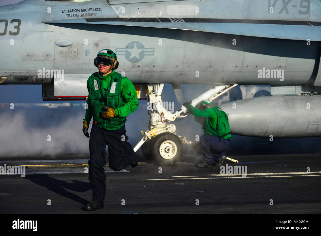 150201-N-TC437-086 PACIFIC OCEAN (Feb. 1, 2015) - Aviation Boatswain's Mate (Equipment) 3rd Class Joel Shrum runs to a safe shot line after connecting a hold back bar to an aircraft on the flight deck of Nimitz-class aircraft carrier USS John C. Stennis (CVN 74). Stennis is currently undergoing an operational training period in preparation for future deployments. (U.S. Navy Photo by Mass Communication Specialist 3rd Class Ignacio D. Perez/ Released) 150201-N-TC437-086 by USS John C. Stennis (CVN 74) Official Stock Photo
