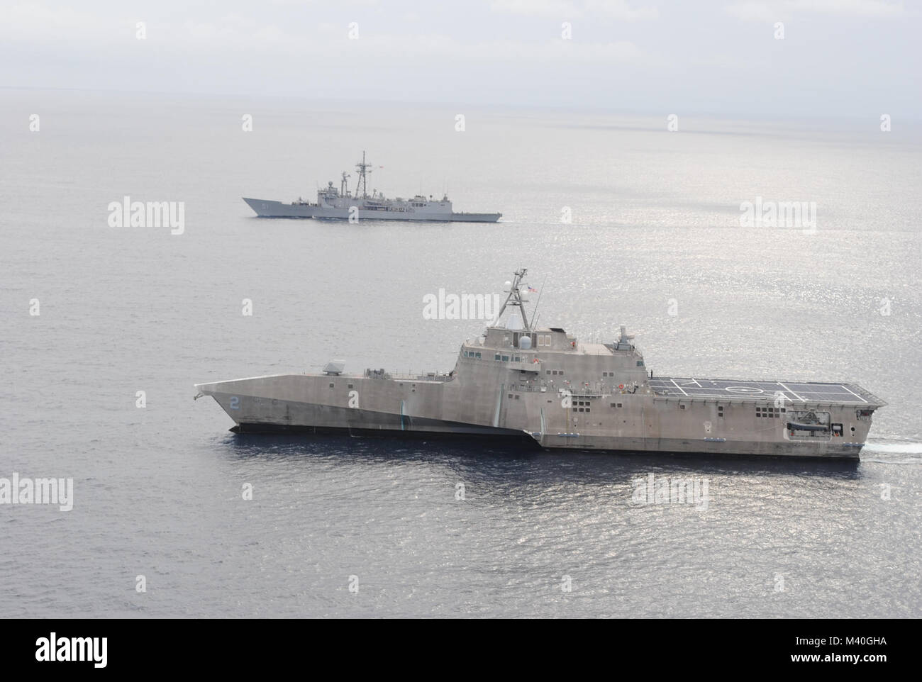 EASTERN PACIFIC (Jan. 06, 2015) - USS Gary (FFG 51) and USS Independence (LCS 2) conduct a photo exercise off the coast of Central America. USS Gary is currently underway in support of Operation Martillo, a joint operation with the U.S. Coast Guard and partner nations within the 4th Fleet area of responsibility. (U.S. Navy photo courtesy of Aircrewman Tactical Helicopter 2nd Class Taylor Petre/Released) 150106-N-WI904-004 by U.S. Naval Forces Southern Command  U.S. 4th Fleet Stock Photo