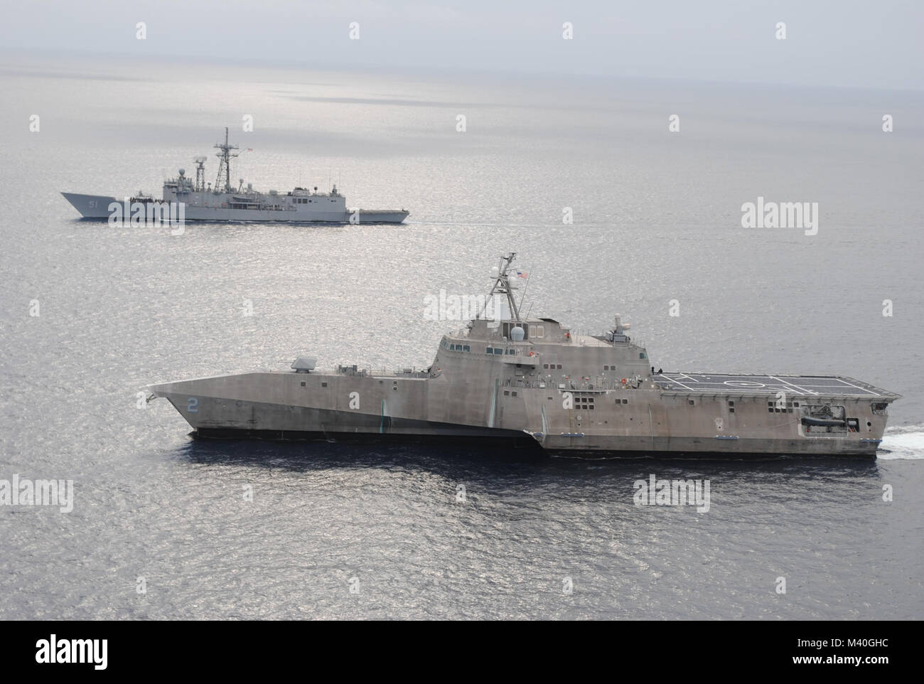 EASTERN PACIFIC (Jan. 06, 2015) - USS Gary (FFG 51) and USS Independence (LCS 2) conduct a photo exercise off the coast of Central America. USS Gary is currently underway in support of Operation Martillo, a joint operation with the U.S. Coast Guard and partner nations within the 4th Fleet area of responsibility. (U.S. Navy photo courtesy of Aircrewman Tactical Helicopter 2nd Class Taylor Petre/Released) 150106-N-WI904-006 by U.S. Naval Forces Southern Command  U.S. 4th Fleet Stock Photo