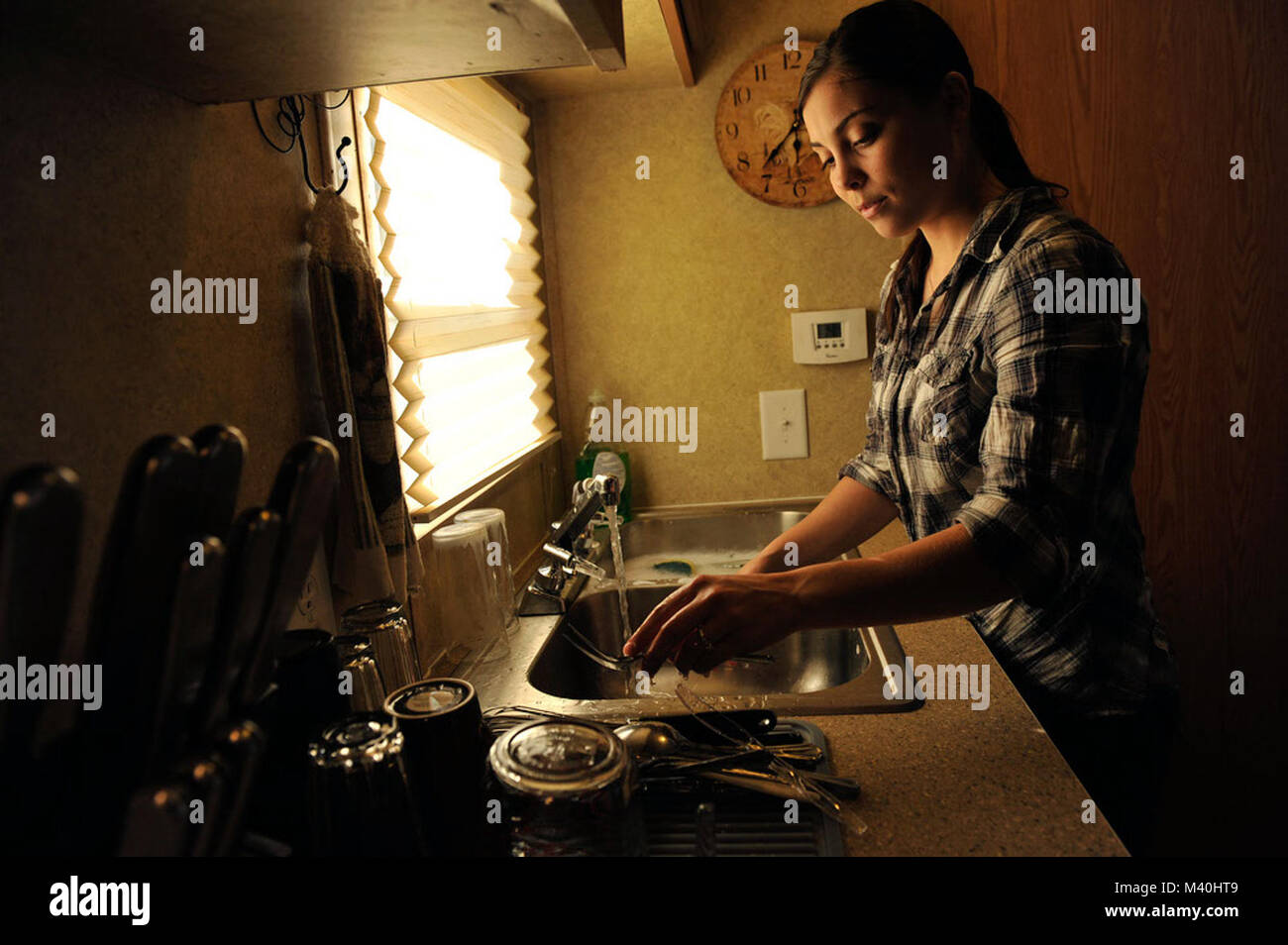 Senior Airman Ashley Woods Washes Dishes In The Small Sink