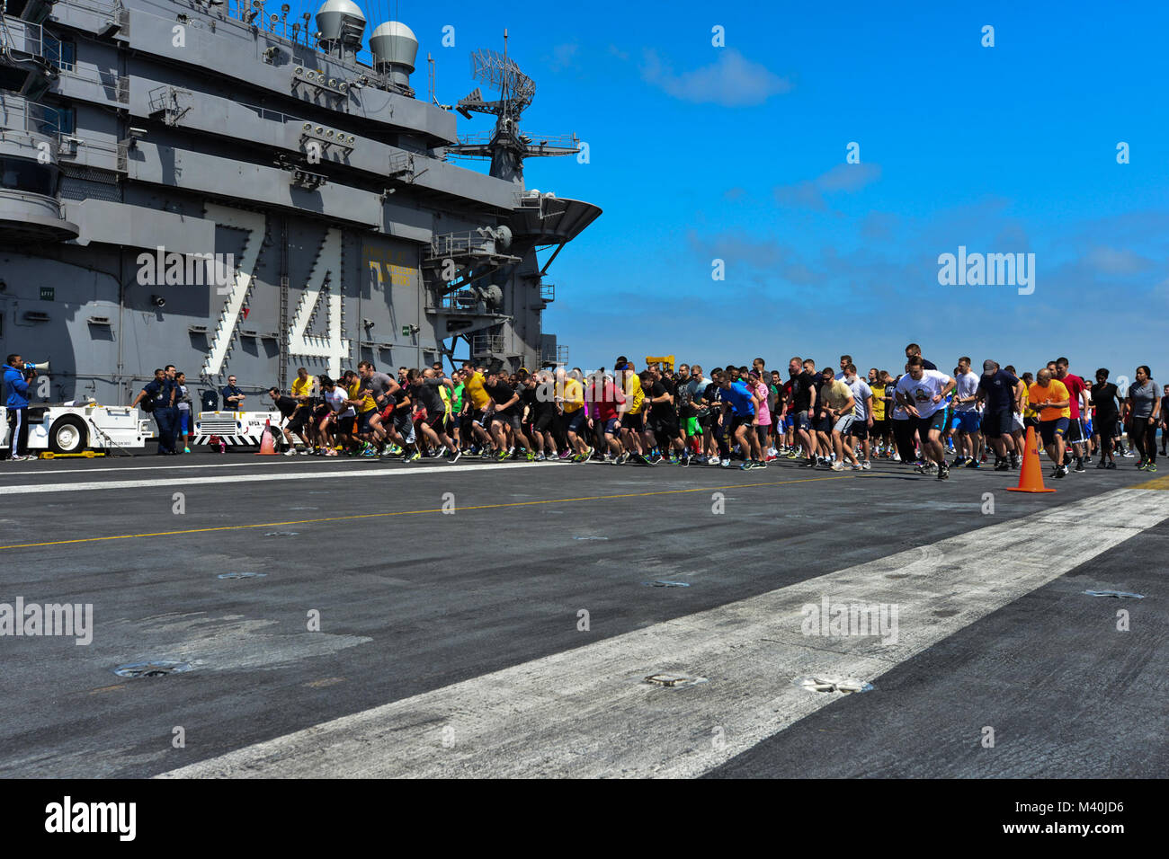 150503-N-IK337-024 PACIFIC OCEAN (May 3, 2015) - Sailors run a 5k on the flight deck of USS John C. Stennis (CVN 74) to raise awareness for the Navy’s Sexual Assault Awareness and Response program.  The ships comprising the John C. Stennis Strike Group (JCSSG) are participating in a Group Sail exercise designed to develop coordinated capabilities. (U.S. Navy Photo by Mass Communication Specialist Seaman Christopher Frost / Released) 150503-N-IK337-024 by USS John C. Stennis (CVN 74) Official Stock Photo
