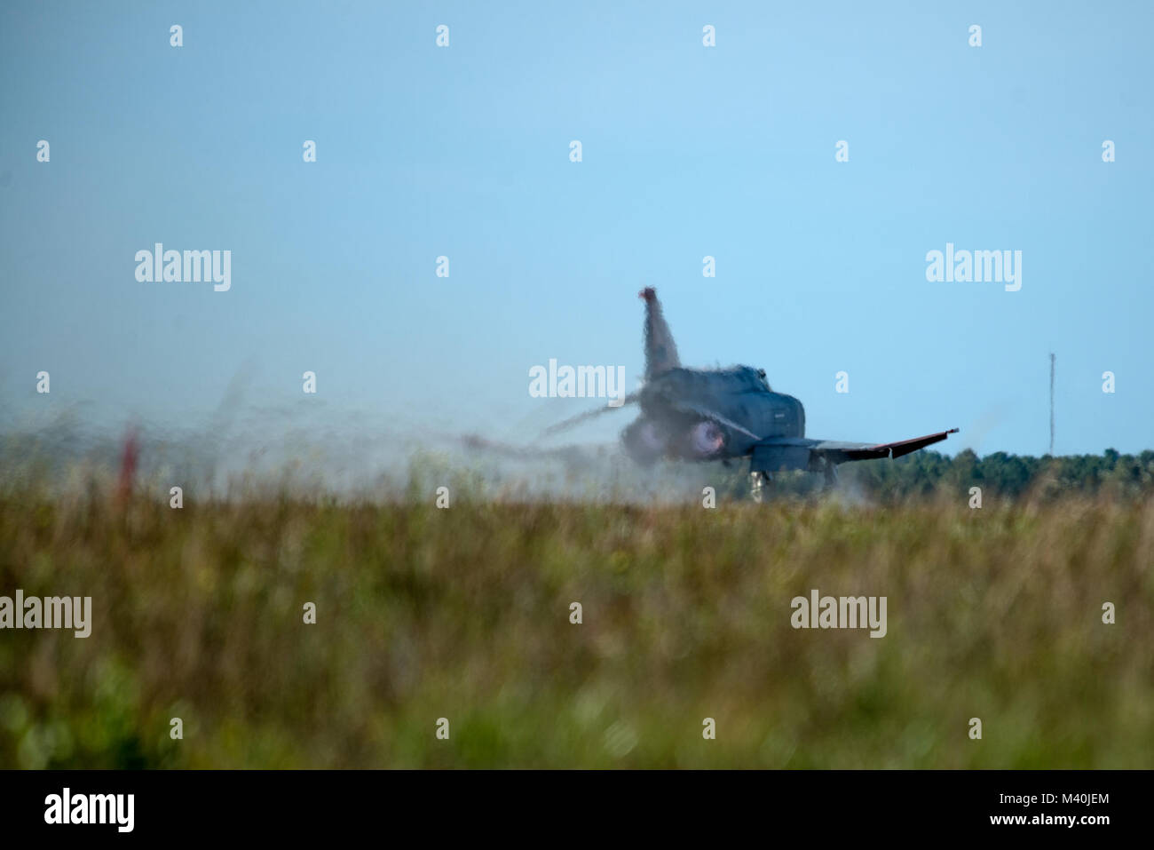 A pilot remotely controls a Q-F4 Phantom as it takes off from the