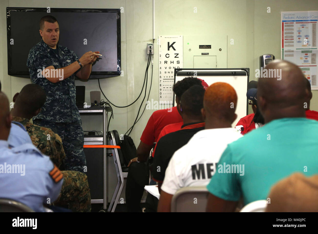 1500509-A-BK746-017 KINGSTON, Jamaica (May 9, 2015) Hospital Corpsman 2nd Class Patrick Gravel, assigned to Naval Medical Center Portsmouth, Va., teaches Jamaican medical professionals about tactical combat casualty care aboard Military Sealift Command hospital ship USNS Comfort (T-AH 20) during Continuing Promise 2015. Continuing Promise is a U.S. Southern Command-sponsored and U.S. Naval Forces Southern Command/U.S. 4th Fleet-conducted deployment to conduct civil-military operations including humanitarian-civil assistance, subject matter expert exchanges, medical, dental, veterinary and engi Stock Photo