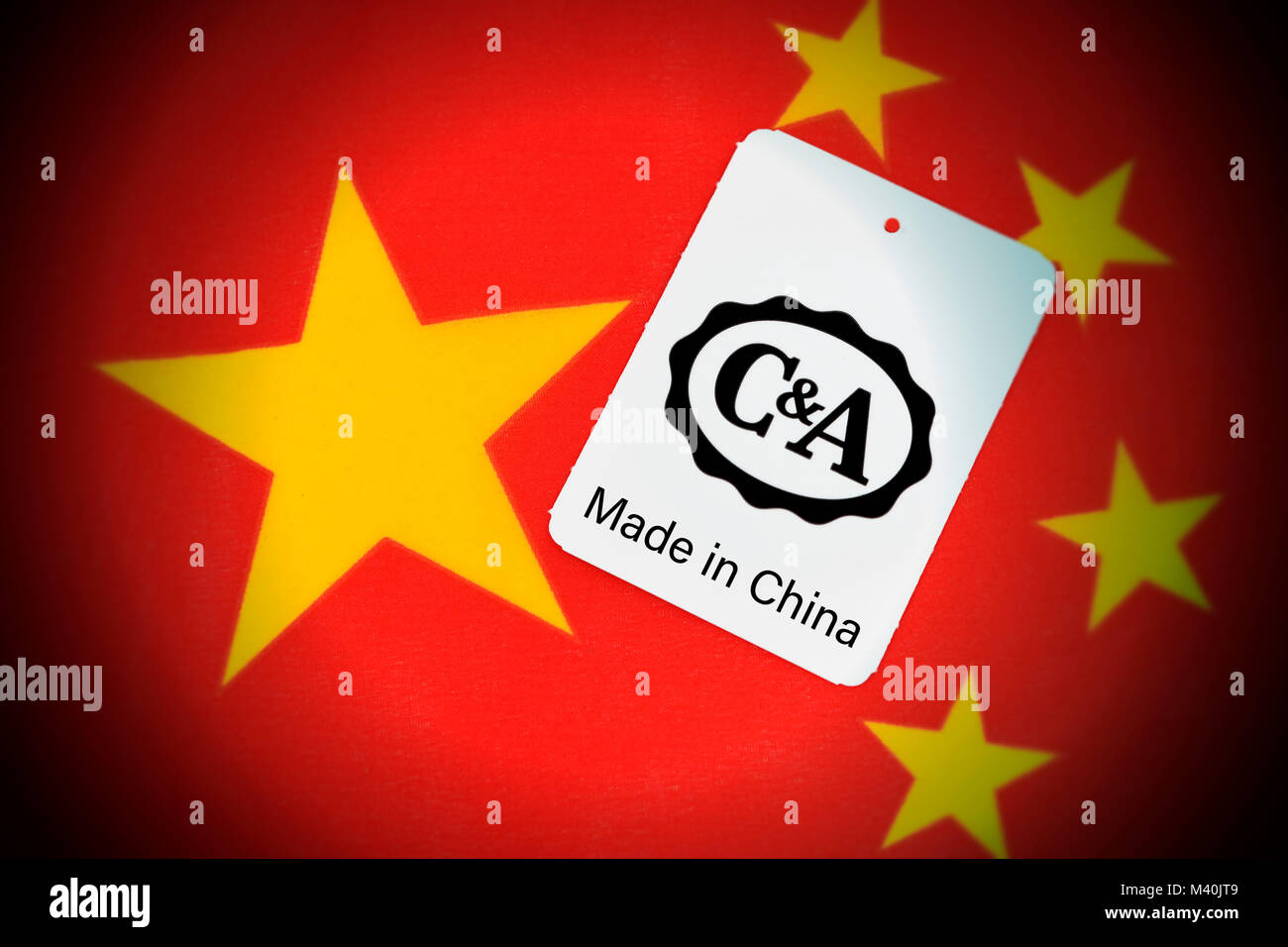 C&A label on Chinese flag, tradition company C&A checks the sale of the company to China, C&A-Etikett auf chinesischer Fahne, Traditionsunternehmen C& Stock Photo
