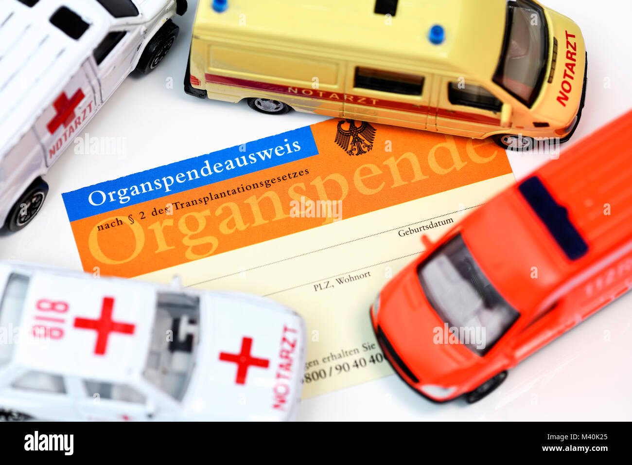 An organ donor card and ambulance, Organspendeausweis und Rettungswagen Stock Photo