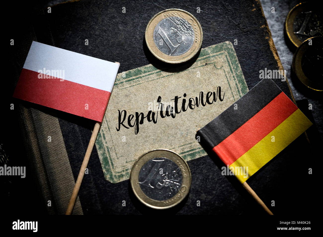 Flags of Germany and Poland and book with the inscription reparations, Fahnen von Deutschland und Polen und Buch mit der Aufschrift Reparationen Stock Photo