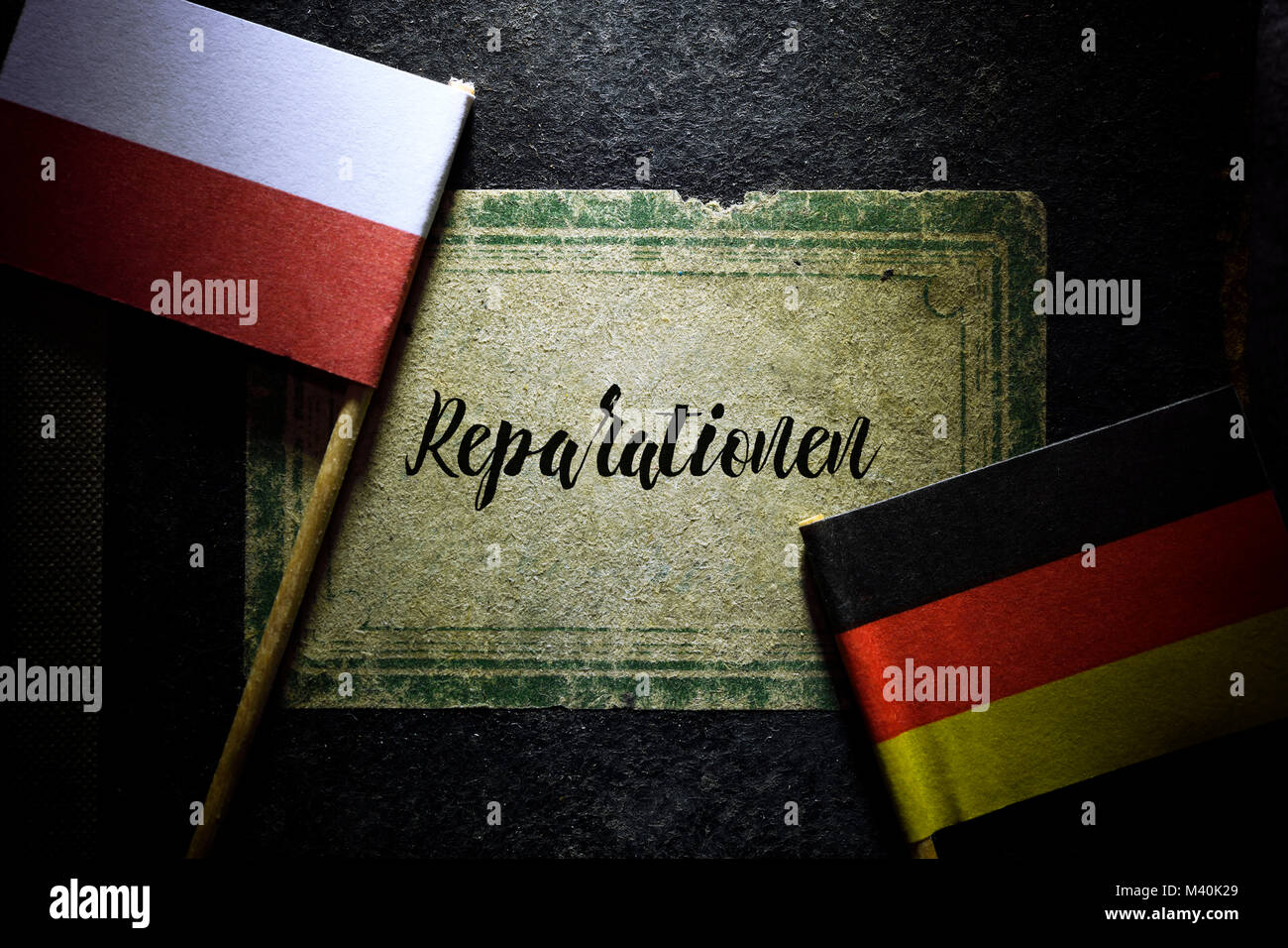 Flags of Germany and Poland and book with the inscription reparations, Fahnen von Deutschland und Polen und Buch mit der Aufschrift Reparationen Stock Photo