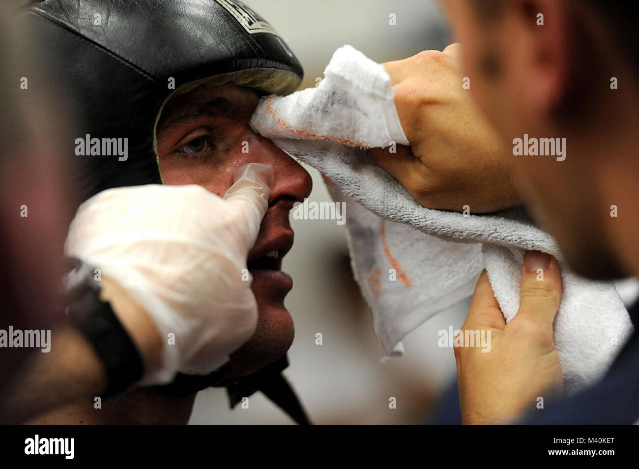 U S Air Force Academy Boxing Coach Capt Blake Baldi Tends To The Cuts On Cadet Second Class Mike Leland Face During His Bout Against U S Army West Point Cadet Jackson Matheson On