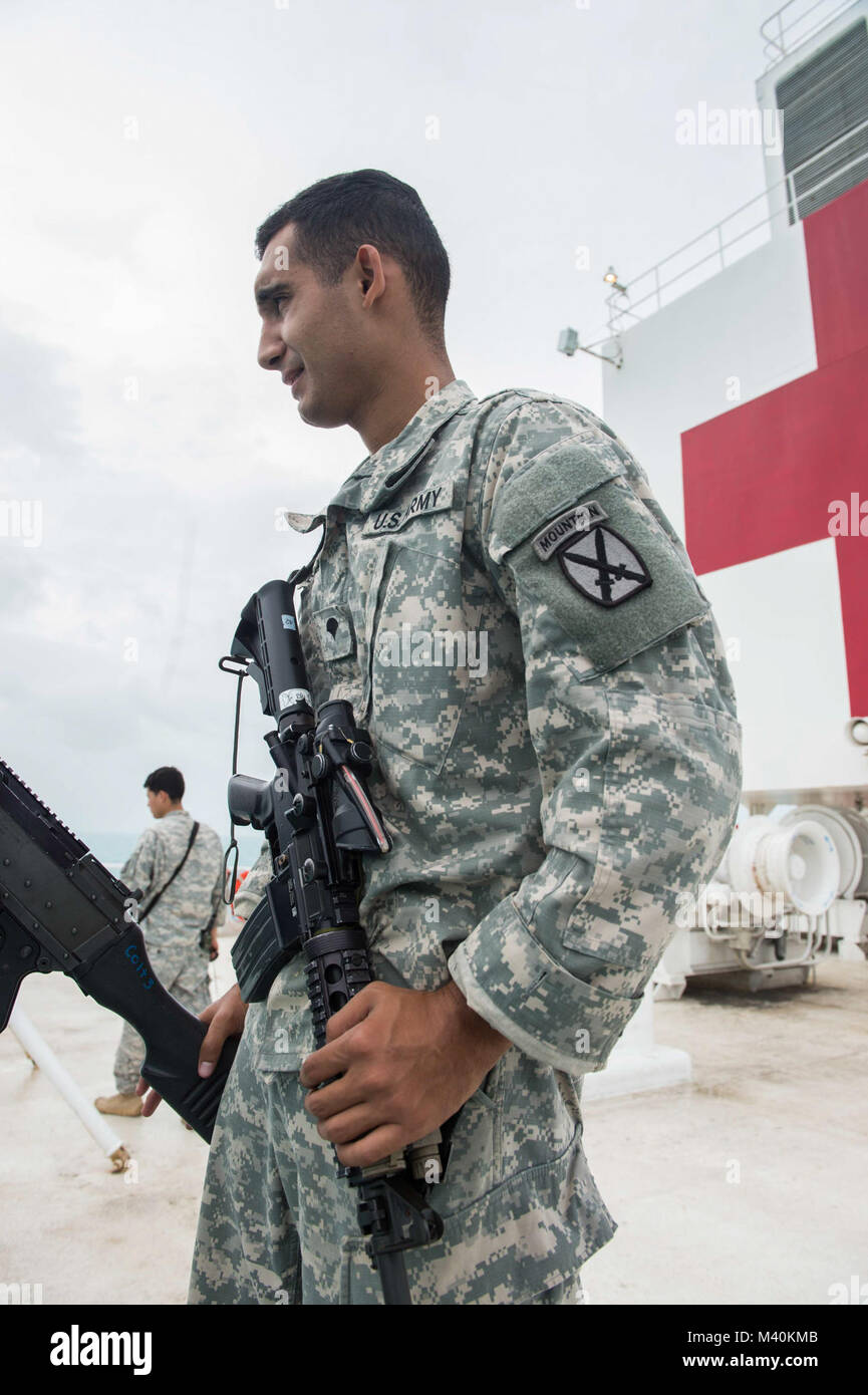 150517-N-PD309-006 CARIBBEAN SEA (May 17, 2015)  Army Spc. Nathaniel Mercado, assigned to 10th Mountain Division Fort Polk, La., stands watch on the stern of Military Sealift Command hospital ship USNS Comfort (T-AH 20) in support of Continuing Promise 2015. Continuing Promise is a U.S. Southern Command-sponsored and U.S. Naval Forces Southern Command/U.S. 4th Fleet-conducted deployment to conduct civil-military operations including humanitarian-civil assistance, subject matter expert exchanges, medical, dental, veterinary and engineering support and disaster response to partner nations and to Stock Photo