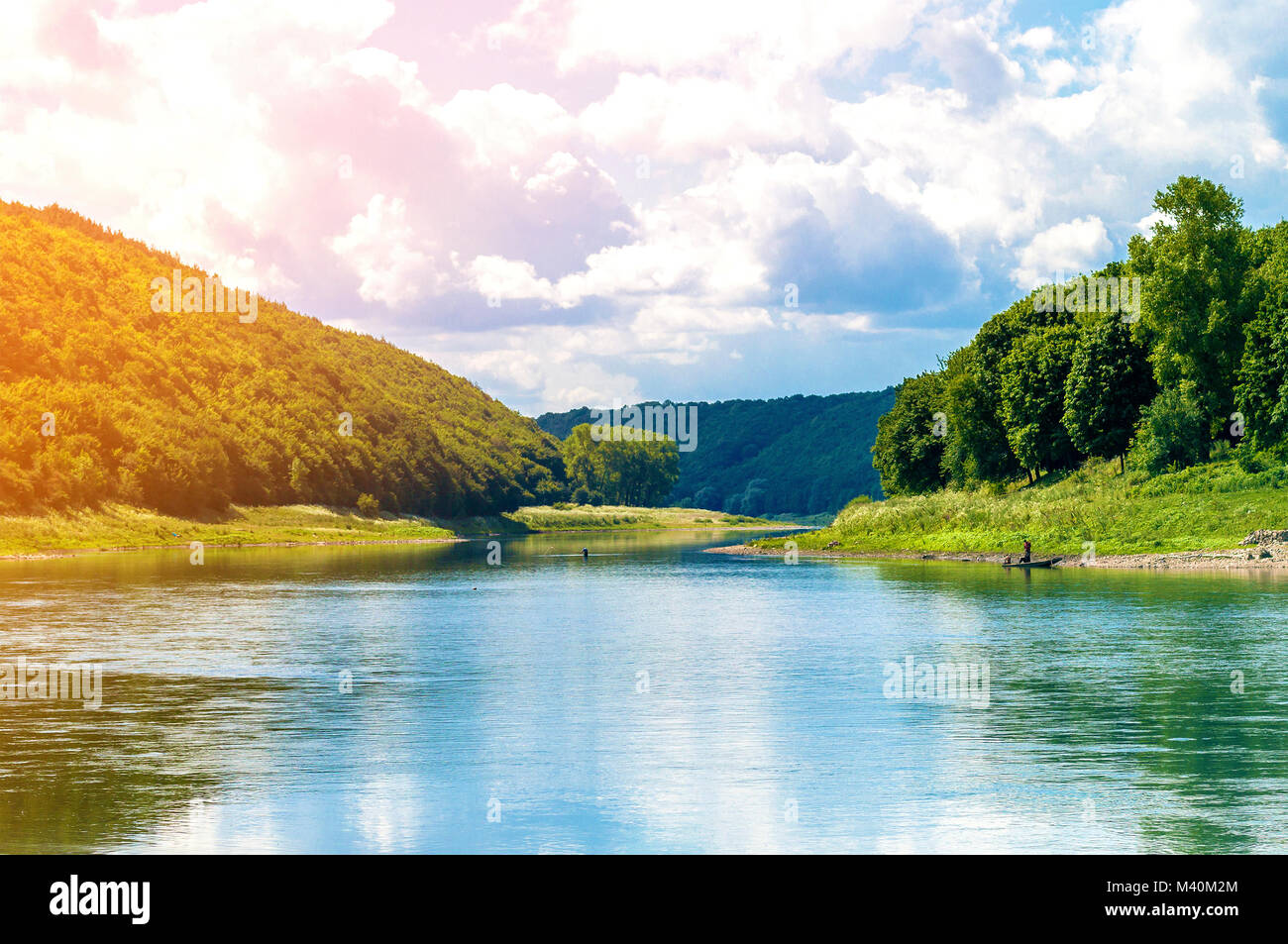 Beautiful landscape with blue water in a river and green trees in ...