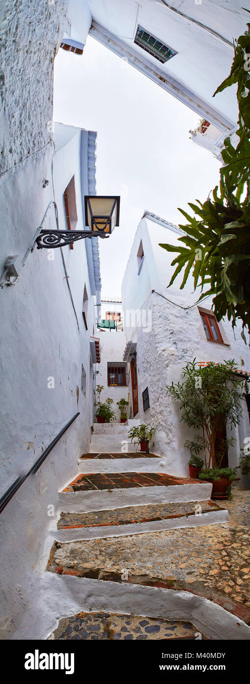Discovering beautiful corners of the spanish mountain village Frigiliana, Costa del Sol, upright panorama Stock Photo