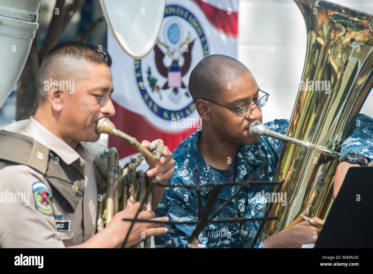 150617-N-PD309-067 SAN JULIAN, El Salvador (June 17, 2015) Musician 1st Class Brad Parrish, a native of Bowling Green, Ky., assigned to the U.S. Fleet Forces Band Uncharted Waters plays alongside a member of the Salvadoran military band, Destacamento Militar 6, at a medical site established at Centro Escolar Doctor Eduardo Enrique Barrientos during Continuing Promise 2015. Continuing Promise is a U.S. Southern Command-sponsored and U.S. Naval Forces Southern Command/U.S. 4th Fleet-conducted deployment to conduct civil-military operations including humanitarian-civil assistance, subject matter  Stock Photo