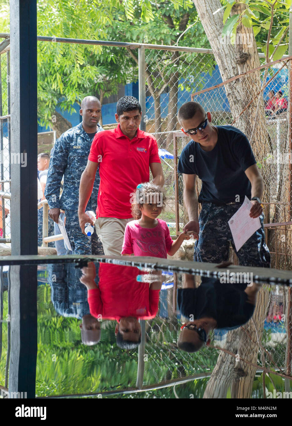 150617-N-PD309-106 SAN JULIAN, El Salvador (June 17, 2015) Hospital Corpsman William Wolff, a native of Wauconda, Ill., assigned to Boone Branch Health Clinic Joint Expeditionary Base Little Creek, Virginia Beach, Va., escorts a patient at a medical site established at Centro Escolar Doctor Eduardo Enrique Barrientos during Continuing Promise 2015. Continuing Promise is a U.S. Southern Command-sponsored and U.S. Naval Forces Southern Command/U.S. 4th Fleet-conducted deployment to conduct civil-military operations including humanitarian-civil assistance, subject matter expert exchanges, medical Stock Photo