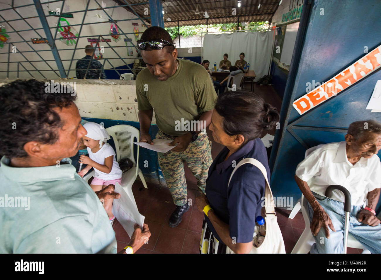 150617-N-PD309-194 SAN JULIAN, El Salvador (June 17, 2015) Leading Seaman Joseph Pugh, a combat medic with the Royal Bahamas Defense Force, directs patients to appropriate care rooms at a medical site established at Centro Escolar Doctor Eduardo Enrique Barriento during Continuing Promise 2015. Partner nation military members are working alongside U.S. service members to support CP-15. Continuing Promise is a U.S. Southern Command-sponsored and U.S. Naval Forces Southern Command/U.S. 4th Fleet-conducted deployment to conduct civil-military operations including humanitarian-civil assistance, su Stock Photo