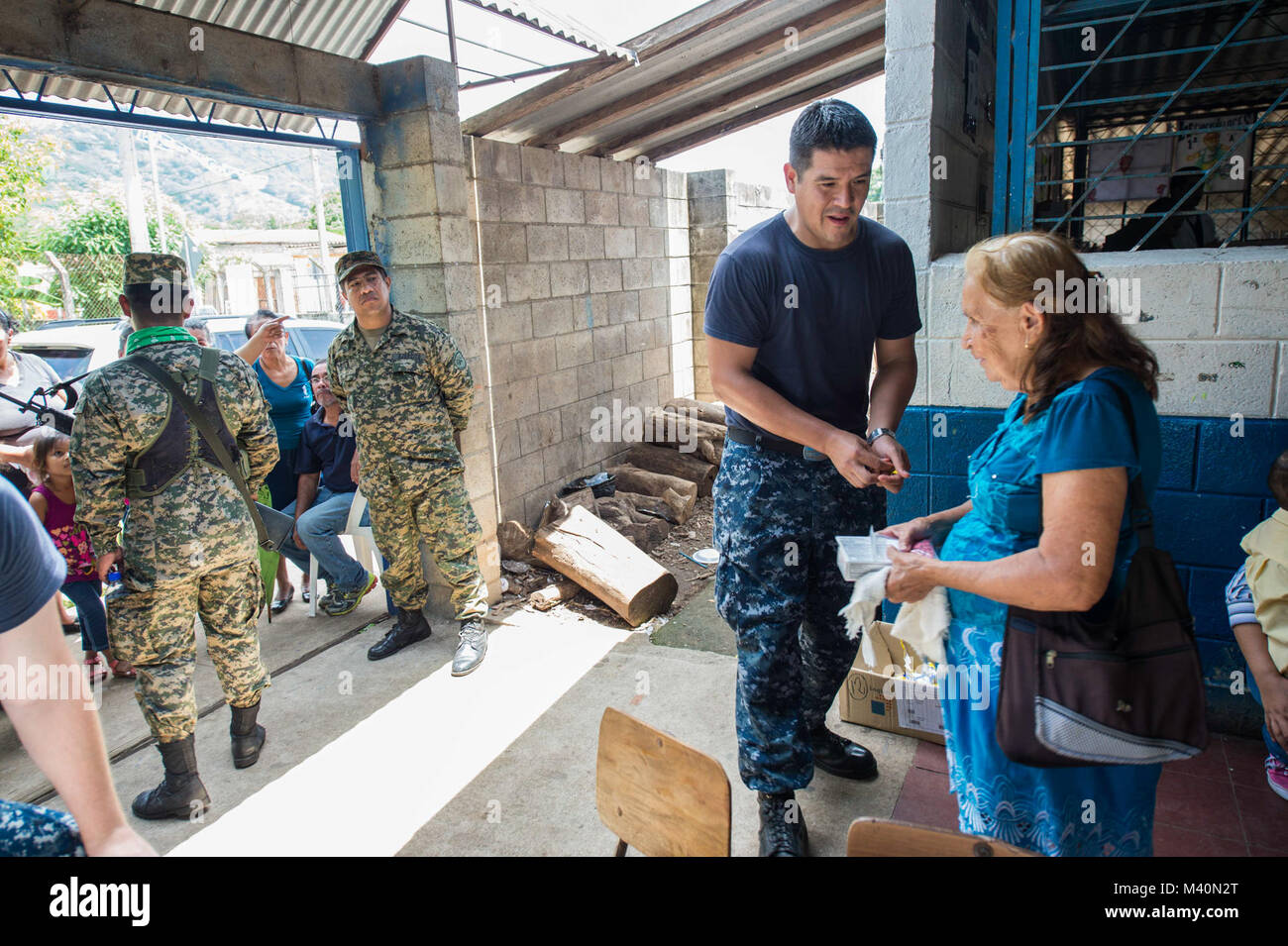 150617-N-PD309-214 SAN JULIAN, El Salvador (June 17, 2015) Ship's Serviceman 2nd Class Gerardo Rangel, a native of Tijuana, Mexico, assigned to Walter Reed National Military Medical Center Bethesda, Md., speaks to a patient at a medical site established at Centro Escolar Doctor Eduardo Enrique Barriento during Continuing Promise 2015. Continuing Promise is a U.S. Southern Command-sponsored and U.S. Naval Forces Southern Command/U.S. 4th Fleet-conducted deployment to conduct civil-military operations including humanitarian-civil assistance, subject matter expert exchanges, medical, dental, vete Stock Photo