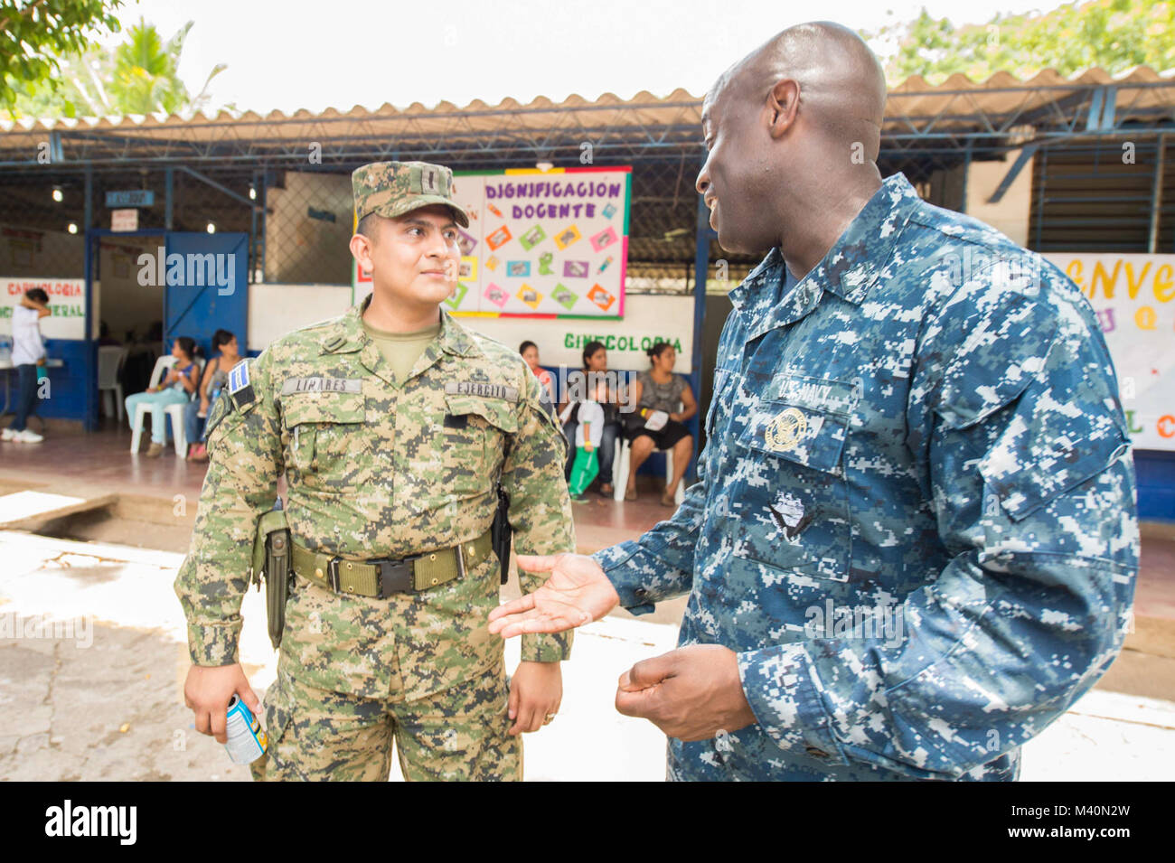 150617-N-PD309-237 SAN JULIAN, El Salvador (June 17, 2015) Musician 2nd Class Vince Moody, right, a native of Severn Md., assigned to the U.S. Fleet Forces Band, Uncharted Waters, speaks to a member of the Salvadoran army at a medical site established at Centro Escolar Doctor Eduardo Enrique Barriento during Continuing Promise 2015. Continuing Promise is a U.S. Southern Command-sponsored and U.S. Naval Forces Southern Command/U.S. 4th Fleet-conducted deployment to conduct civil-military operations including humanitarian-civil assistance, subject matter expert exchanges, medical, dental, veteri Stock Photo