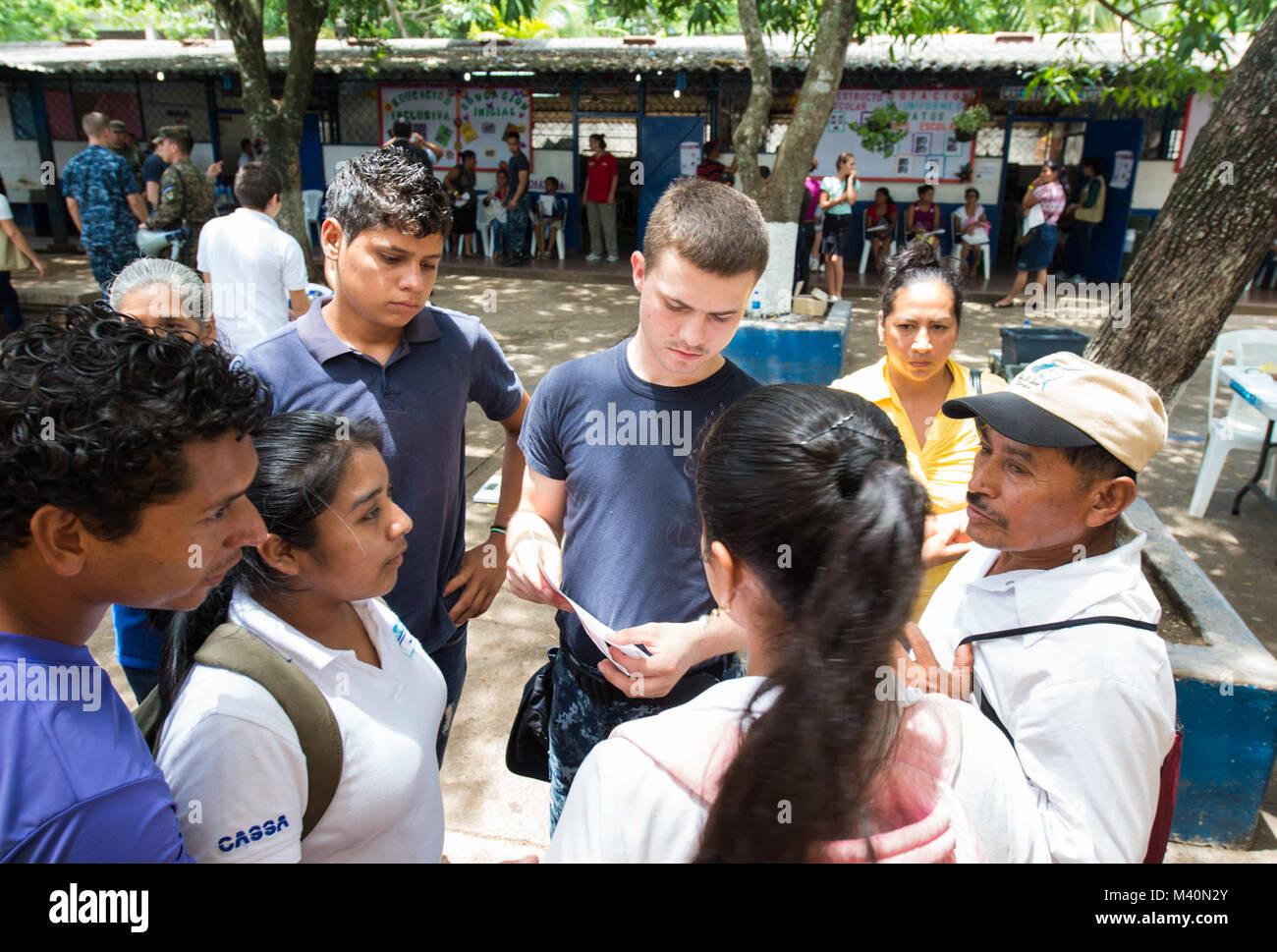 150617-N-PD309-259 SAN JULIAN, El Salvador (June 17, 2015) Hospitalman Donald Embrey, a native of Mineral, Va., assigned to Naval Air Station Oceana Branch Health Clinic Dam Neck Annex, Va., speaks with patients at a medical site established at Centro Escolar Doctor Eduardo Enrique Barrientos during Continuing Promise 2015. Continuing Promise is a U.S. Southern Command-sponsored and U.S. Naval Forces Southern Command/U.S. 4th Fleet-conducted deployment to conduct civil-military operations including humanitarian-civil assistance, subject matter expert exchanges, medical, dental, veterinary and  Stock Photo