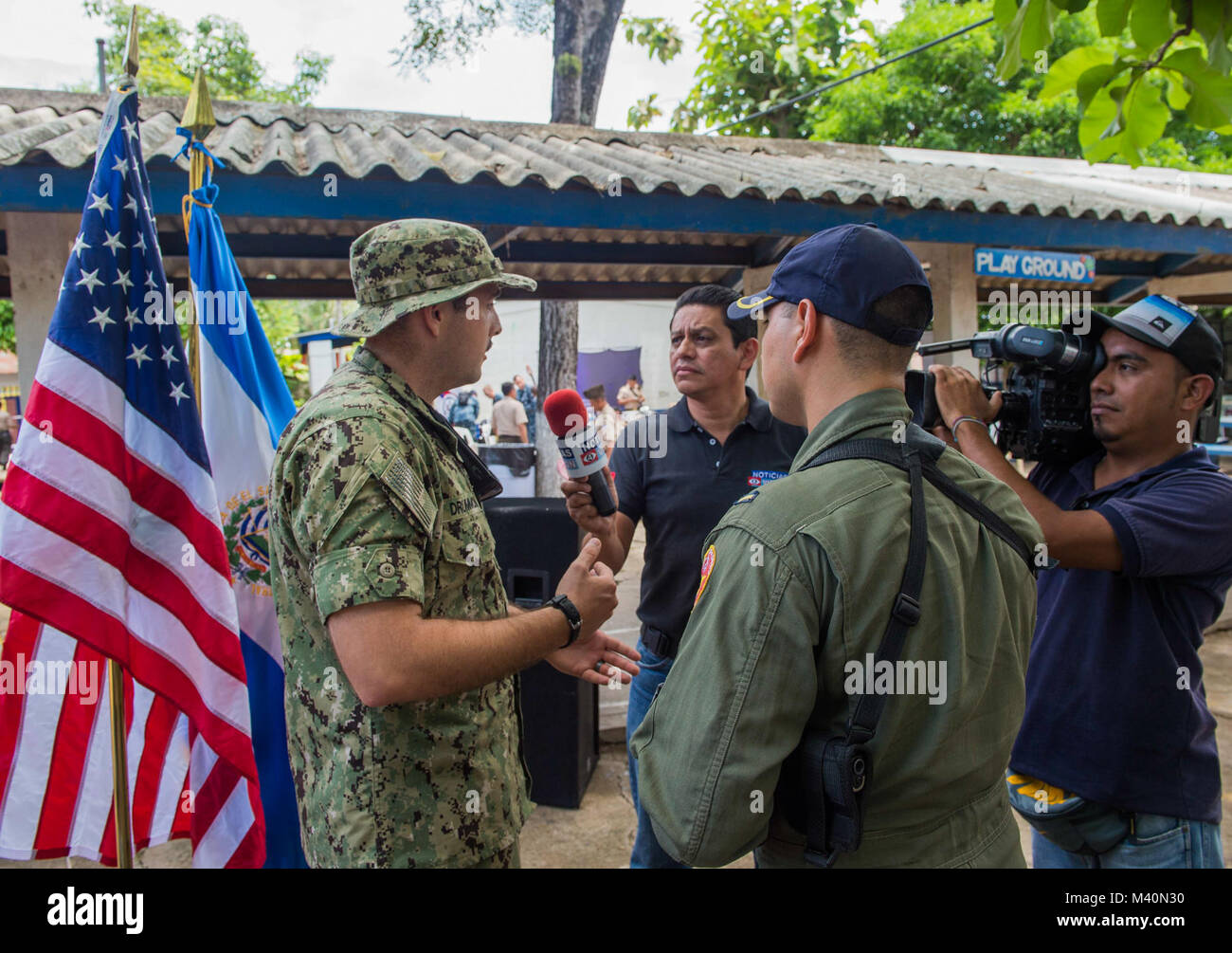 150617-N-PD309-288 SAN JULIAN, El Salvador (June 17, 2015) Lt. j.g. Will Drummond, a native of Fort Worth, Texas, assigned to Destroyer Squadron 40, speaks to members of the Salvadoran press at a medical site established at Centro Escolar Doctor Eduardo Enrique Barrientos during Continuing Promise 2015. Continuing Promise is a U.S. Southern Command-sponsored and U.S. Naval Forces Southern Command/U.S. 4th Fleet-conducted deployment to conduct civil-military operations including humanitarian-civil assistance, subject matter expert exchanges, medical, dental, veterinary and engineering support a Stock Photo
