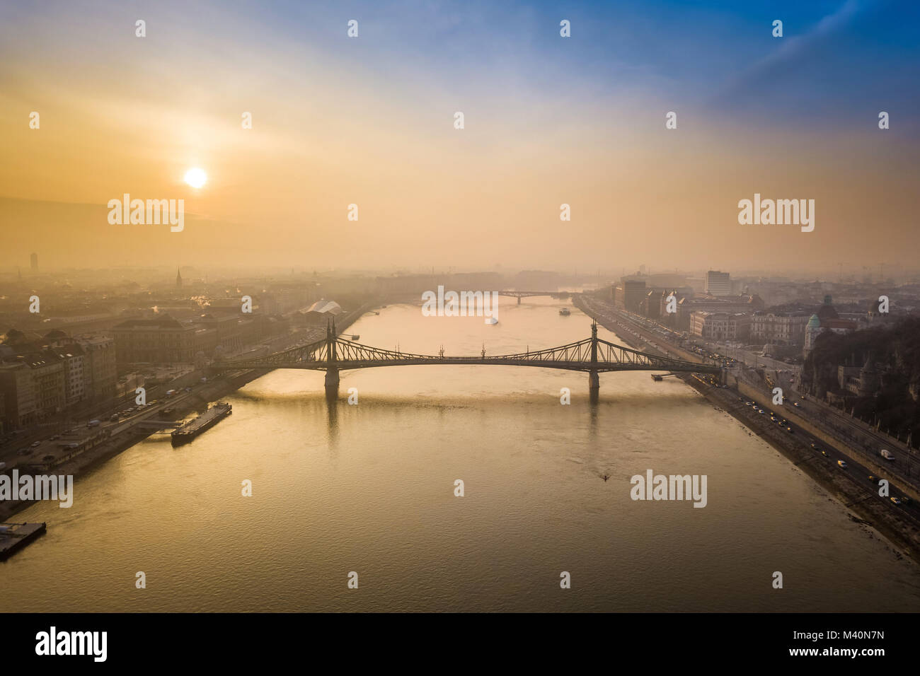 Budapest, Hungary - Aerial panoramic skyline view of Liberty Bridge (Szabadsag Hid) over River Danube at sunrise with beautiful sky and clouds Stock Photo