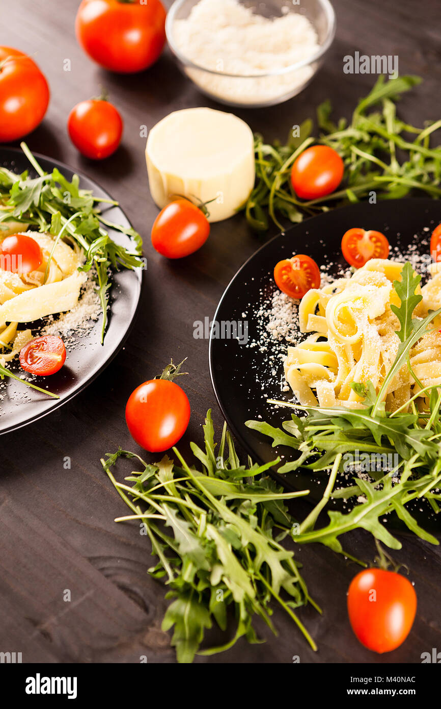 Tagliatelli pasta on wooden table Stock Photo