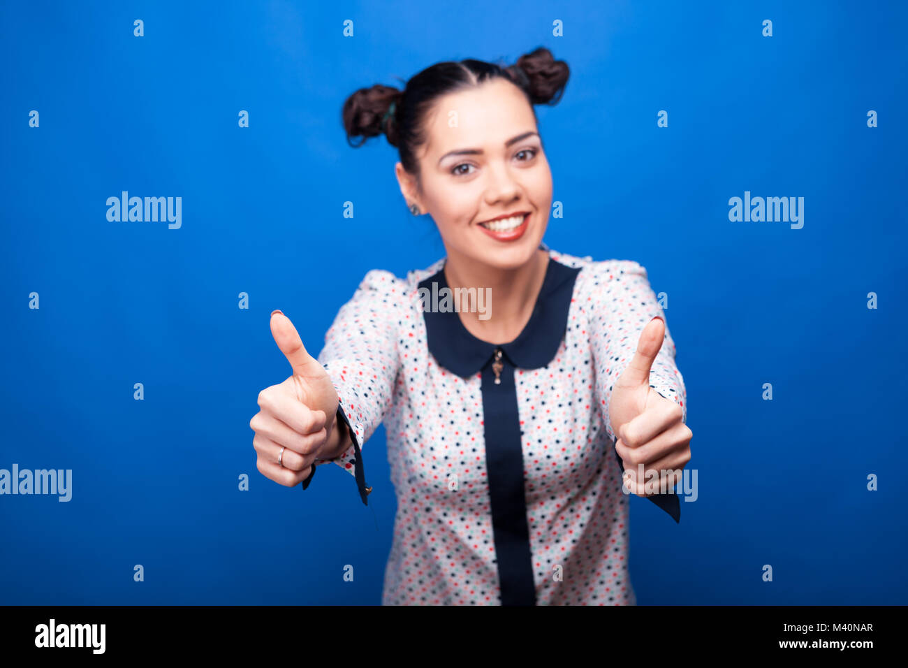 Happy woman showing thumbs up Stock Photo - Alamy