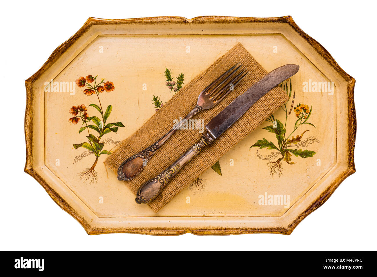 Antique tray with old cutlery spoon and knife isolated on white background, view from above, flatlay. Stock Photo