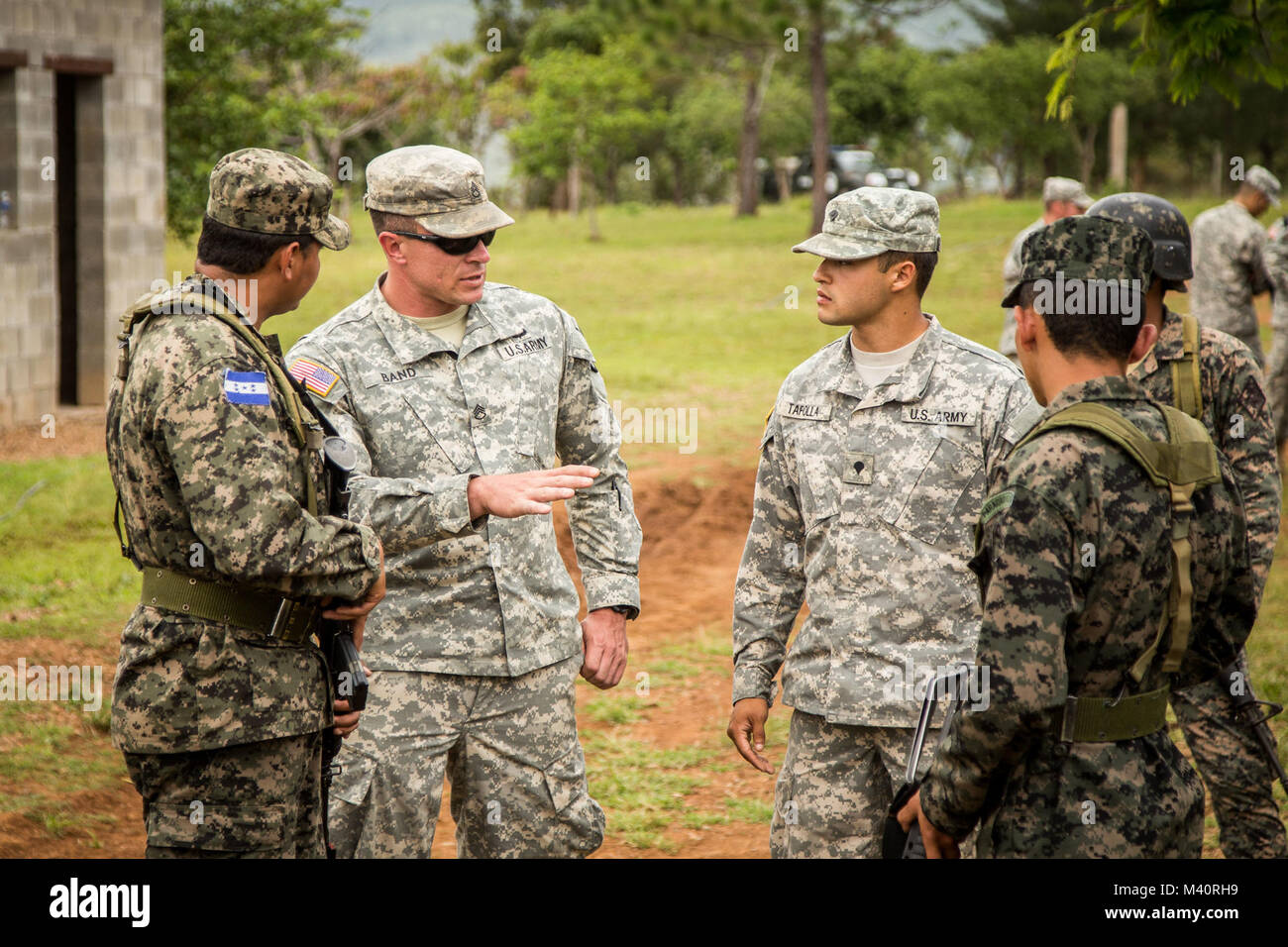 Staff Sgt. Jason Band (left) and Spec. Carlos Tafolla (right) work with Honduran soldiers during a training exercise in Tamara, Honduras. Both 36th Infantry Division soldiers are with the San Antonio-based 1st Battalion, 141st Infantry Regiment (Task Force Alamo), which is conducting the training to enhance the Honduran Army’s ability to counter transnational organized crime (CTOC). These Regionally Aligned Forces of the Texas Army National Guard are in Central America creating a knowledgeable and trained force that is able to detect, disrupt and detain illicit trafficking across the region. ( Stock Photo