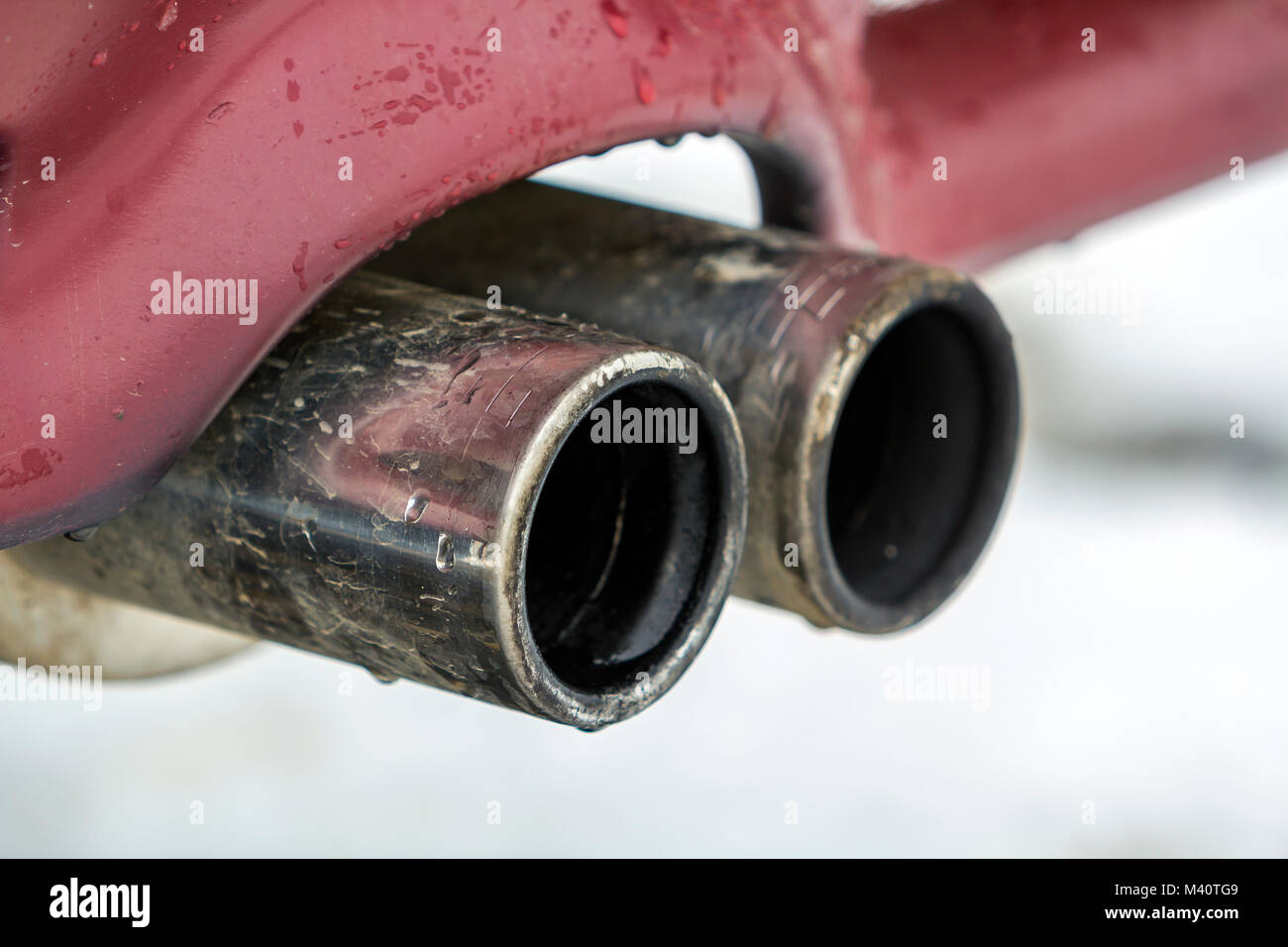 Close up image of a car dual exhaust pipe. Emission of poisonous carbon