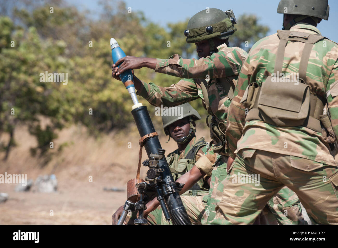 Soldiers with the Zambian Defense Force load a mortar training round