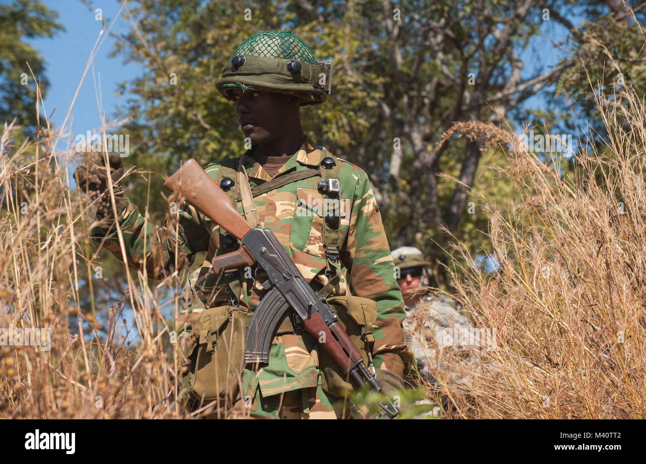 A soldier with the Zambian Defense Force signals to a United States