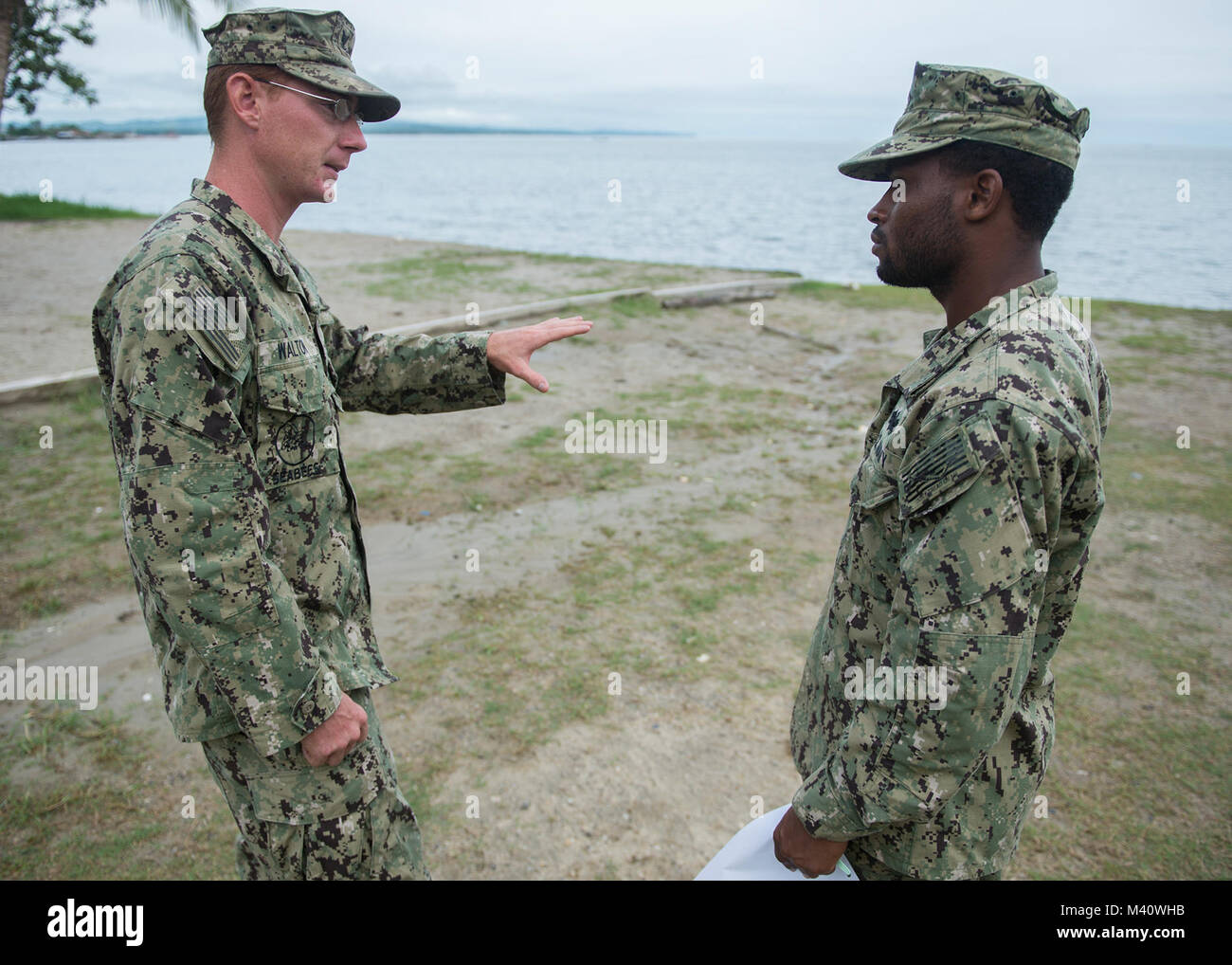 {150828-N-XY744-067} PUERTO BARRIOS, Guatemala (August 28, 2015) Builder 2nd Class Adam Walton and Builder 2nd Class Royshawn Ferguson, assigned to Construction Battalion Maintenance Unit 303 (CBMU 303), in San Diego, discuss their plans for construction projects in Puerto Barrios, Guatemala, on Aug. 28. Walton and Ferguson are deployed as part of the Adaptive Force Package in support of Southern Partnership Station Joint High Speed Vessel 2015(SPS- JHSV 15). SPS –JHSV 15 is an annual series of U.S. Navy deployments, fostering a lasting relationship with the host nations by promoting and enhan Stock Photo