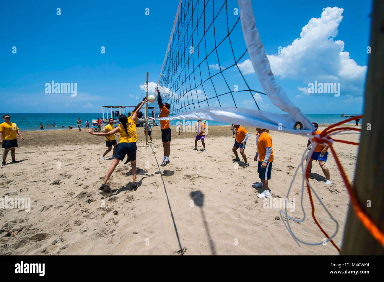 150830-N-NK134-172 TRUJILLO, Honduras (Aug. 30, 2015) - Sailors, assigned to Military Sealift Command hospital ship USNS Comfort (T-AH 20), participate in a volleyball game with Honduran service members at Cortesia de Restaurante during a community relations event in support of Continuing Promise 2015. Continuing Promise is a U.S. Southern Command-sponsored and U.S. Naval Forces Southern Command/U.S. 4th Fleet-conducted deployment to conduct civil-military operations including humanitarian-civil assistance, subject matter expert exchanges, medical, dental, veterinary and engineering support an Stock Photo