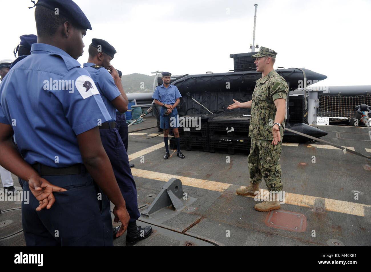 120319-N-BJ279-175  CHAGUARAMAS, Trinidad and Tobago â (March 19, 2012) Navy Diver 1st Class Shane Parton, assigned to Mobile Diving and Salvage Unit (MDSU) 2, Company 2-1, talks to Trinidad and Tobago Sailors about the towing and salvage capabilities of the Military Sealift Command rescue and salvage ship USNS Grapple (T-ARS 53). Company 2-1 is participating in Navy Dive Southern Partnership Station 2012, a multinational partnership engagement designed to increase interoperability and partner nation capacity through diving operations. (U.S. Navy photo by Mass Communication Specialist 2nd Clas Stock Photo