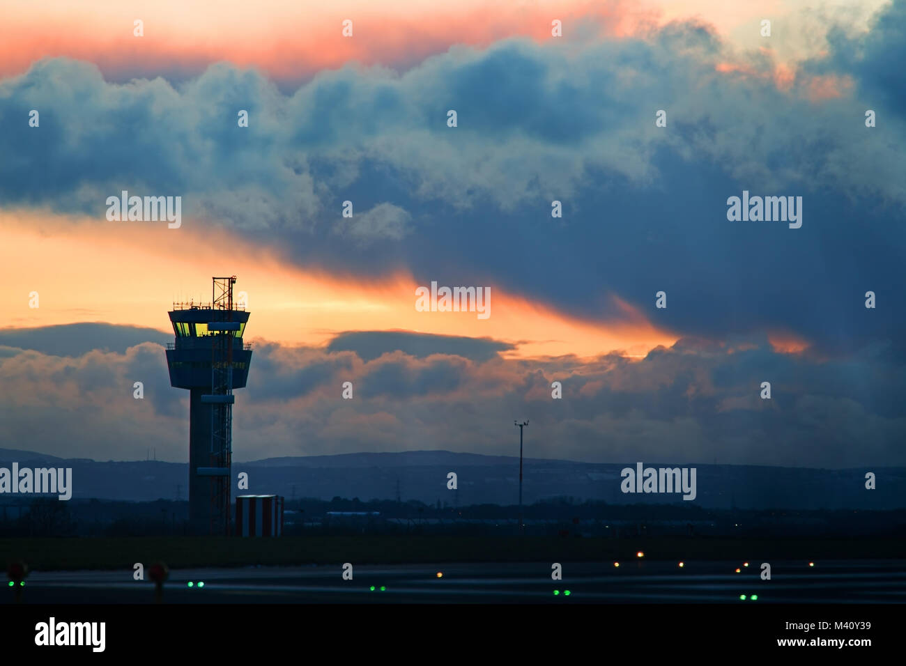 Liverpool John Lennon Airport Air Traffic control tower against a stormy sky at dusk Stock Photo