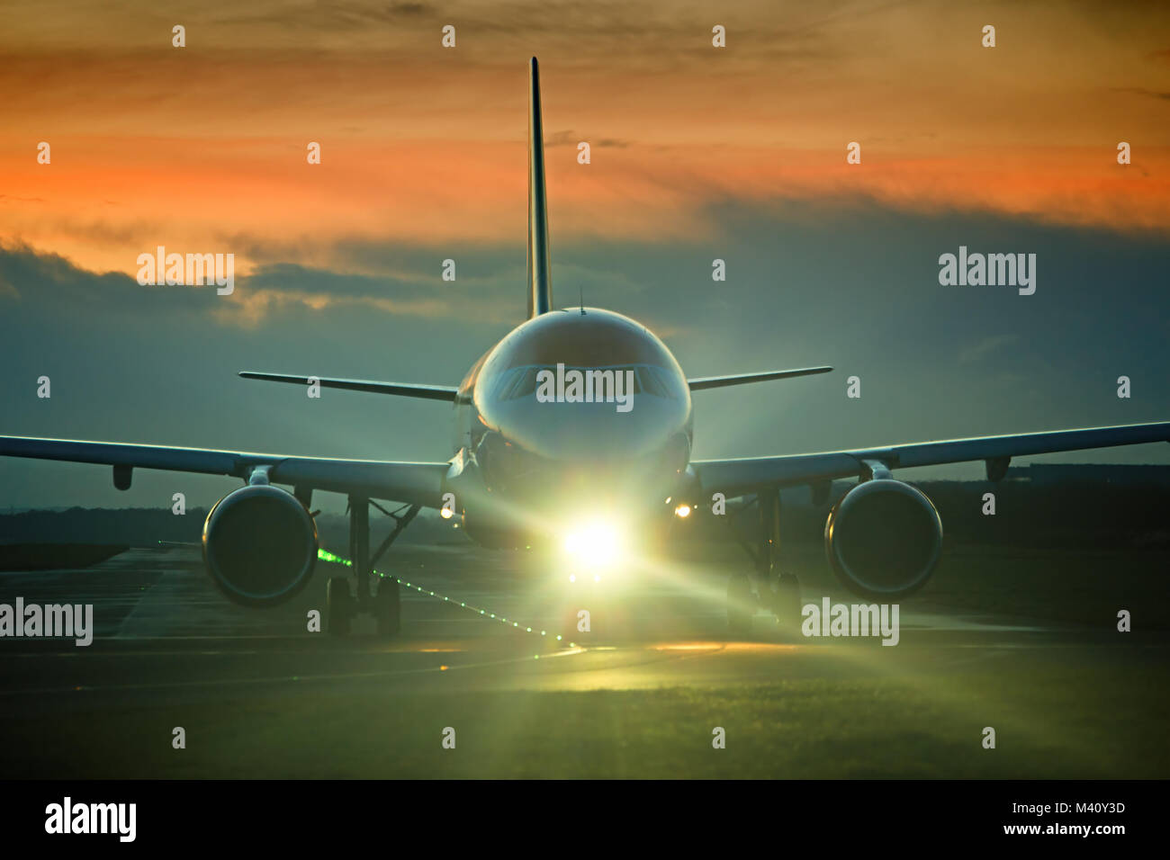 An Easyjet passenger plane taxiing out to the runway for take off at Liverpool John Lennon Airport at dusk. Stock Photo
