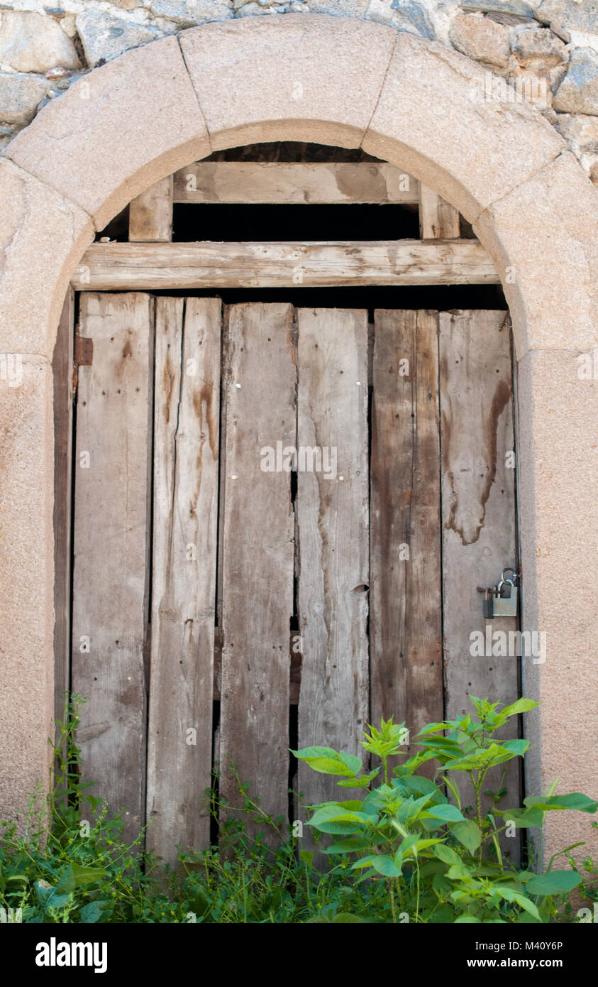 Ancient wooden door in stone wall Stock Photo - Alamy