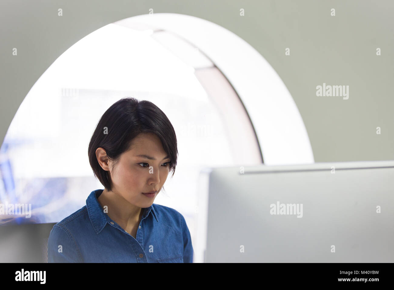 Asian businesswoman working on a desktop computer Stock Photo