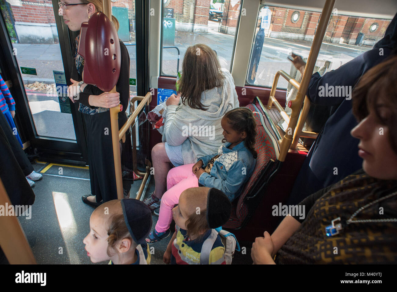 London, United Kingdom. Jewish family in a bus. Stock Photo
