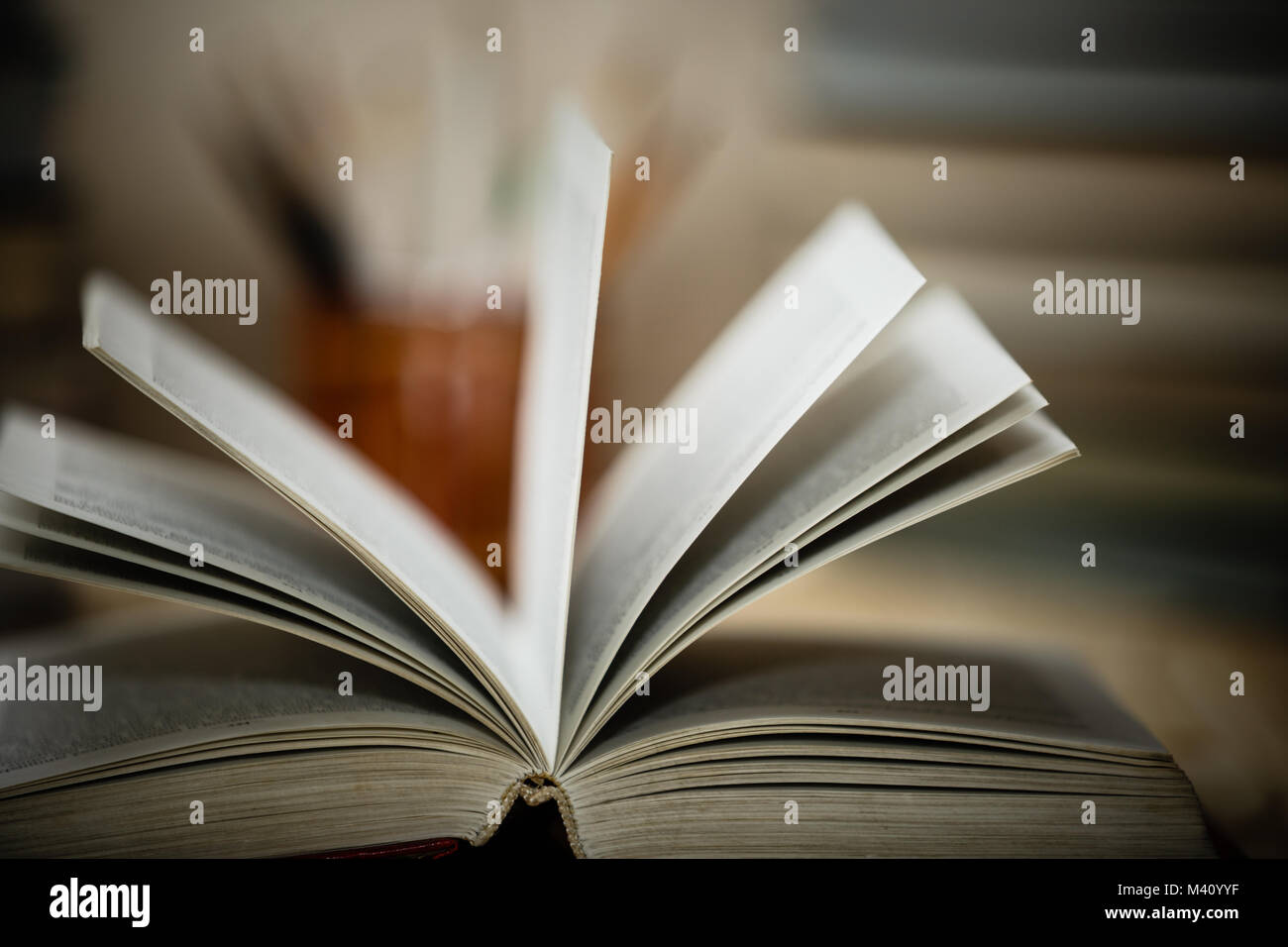Open textbooks on wood desk with blurred focus for education background. Back to school concept Stock Photo