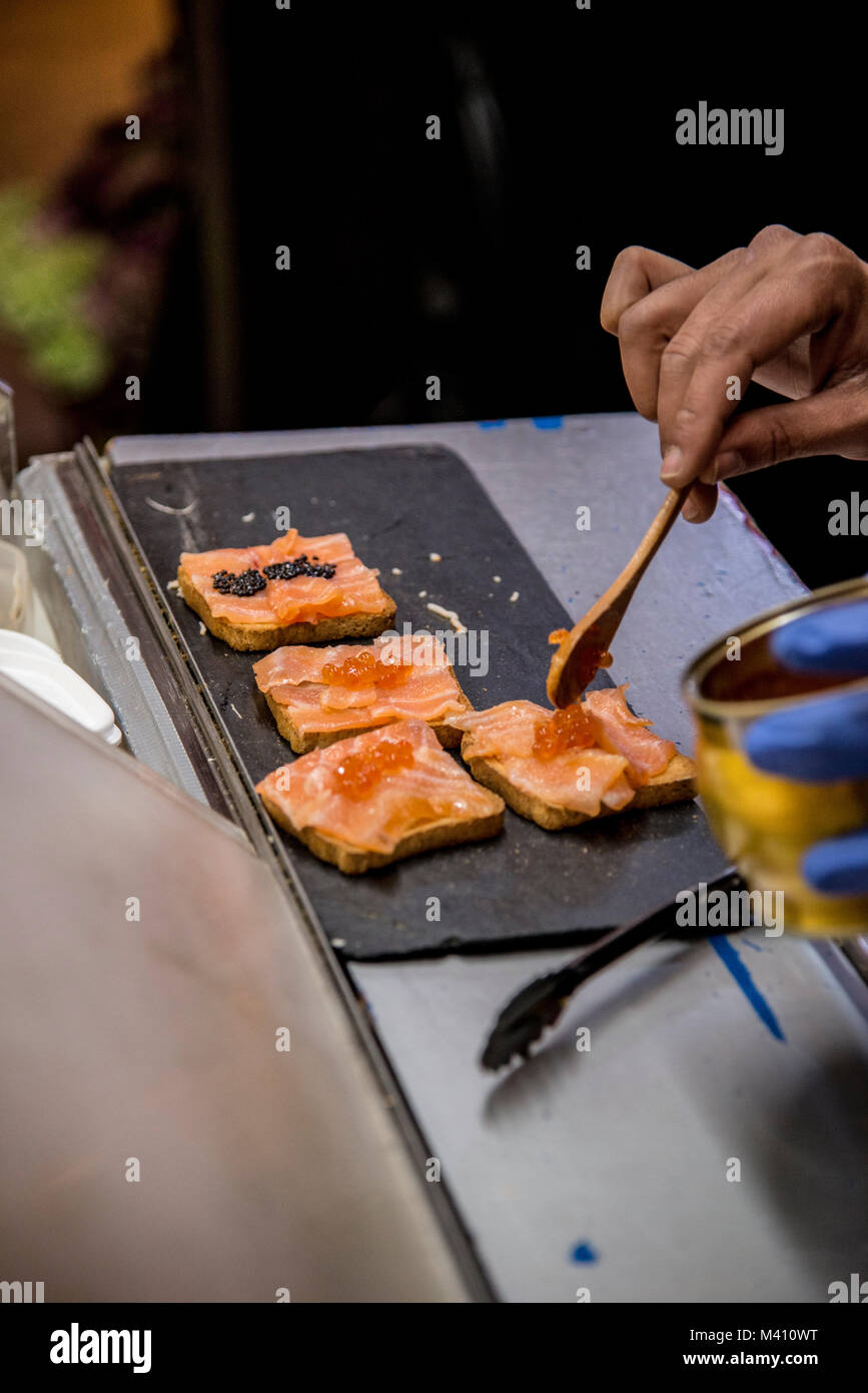 Serving caviar on blinis at the market San Miguel in central Madrid Stock Photo