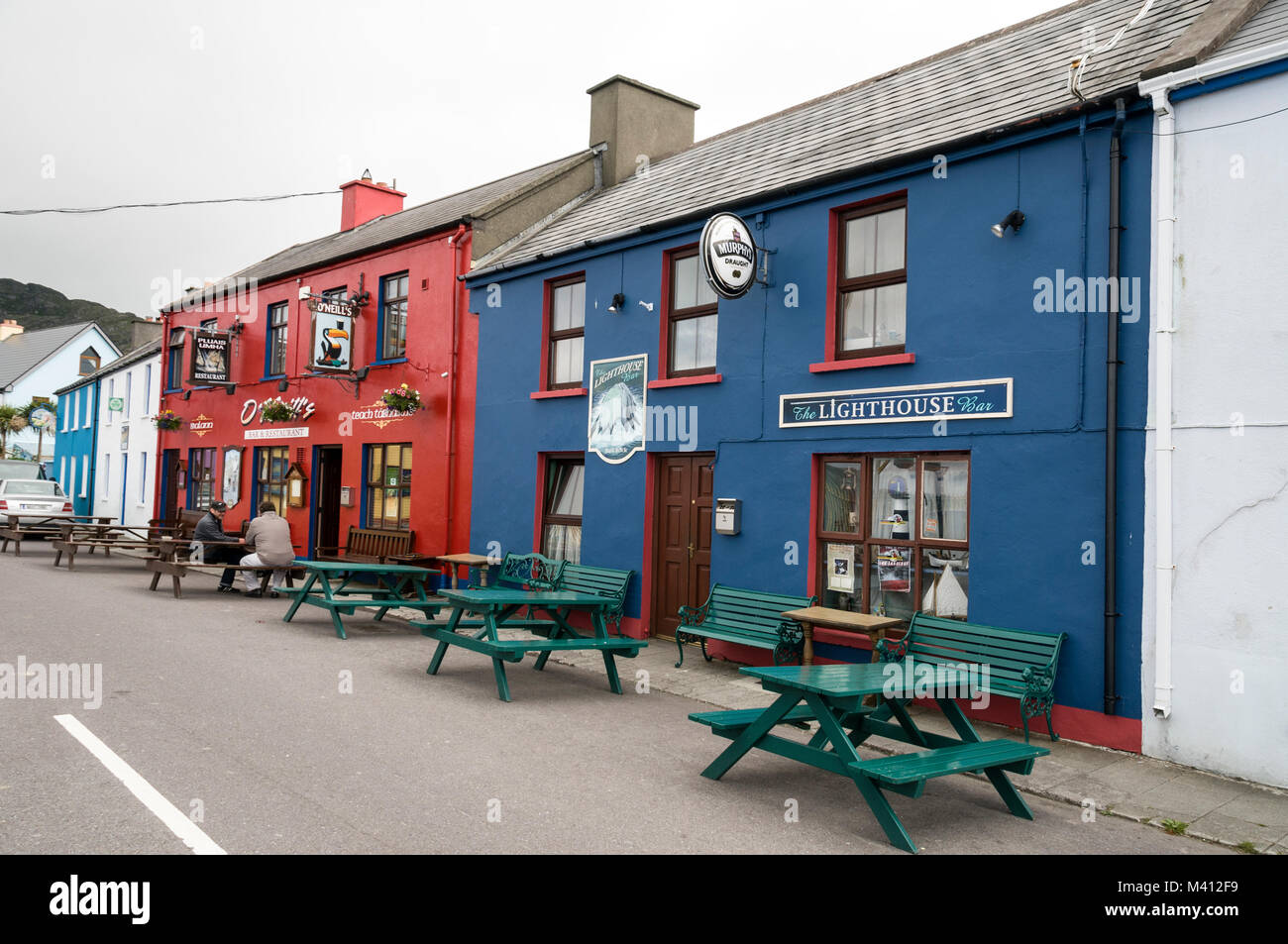Two pubs next door to each other: O'Neil's pub and the Lighthouse bar in Allihies on the Beara Peninsula. Southern Ireland. Stock Photo