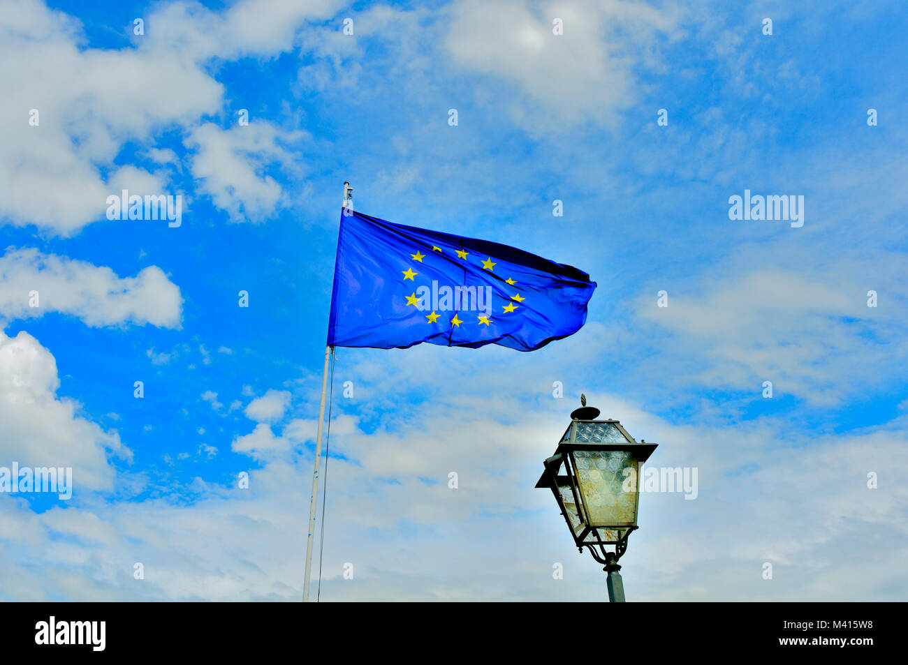 EU flag flying against a bright sky in Argegno, Province of Como, italy Stock Photo
