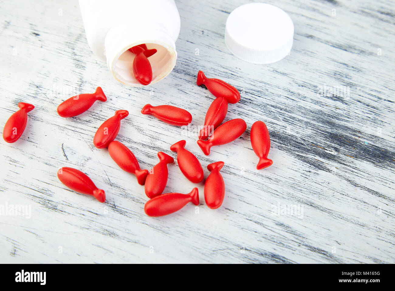 Download Omega 3 In Fish Shaped Red Capsules Of Fish Oil In Bottle On White Stock Photo Alamy PSD Mockup Templates