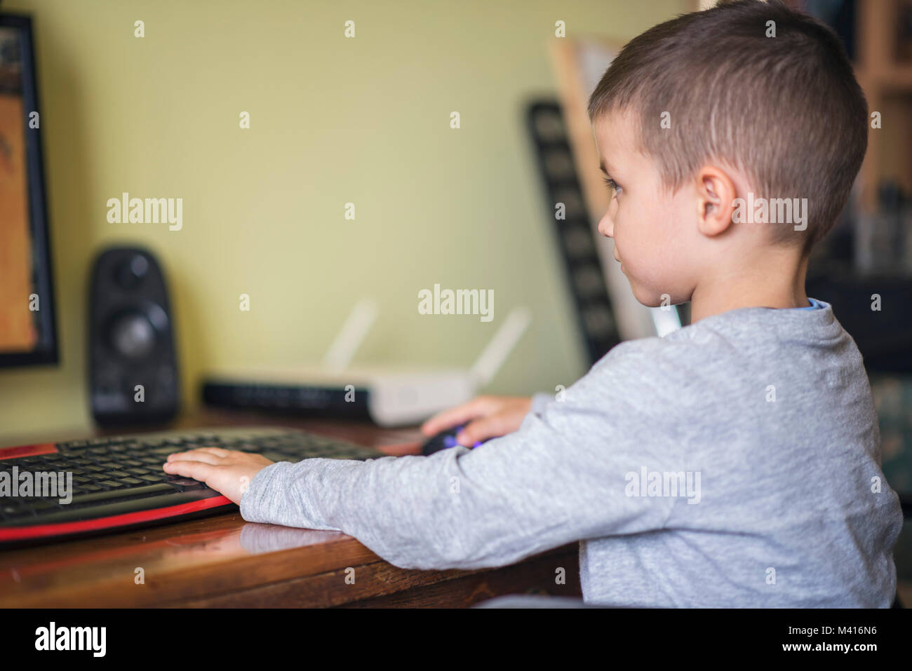 Young boy playing games on a desktop computer Stock Photo