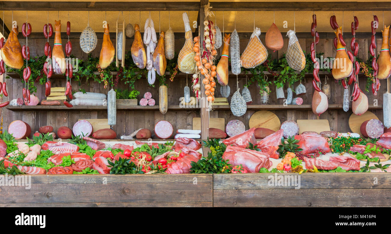 fresh food market background with raw pork and vertical assorted salami sausages. Stock Photo