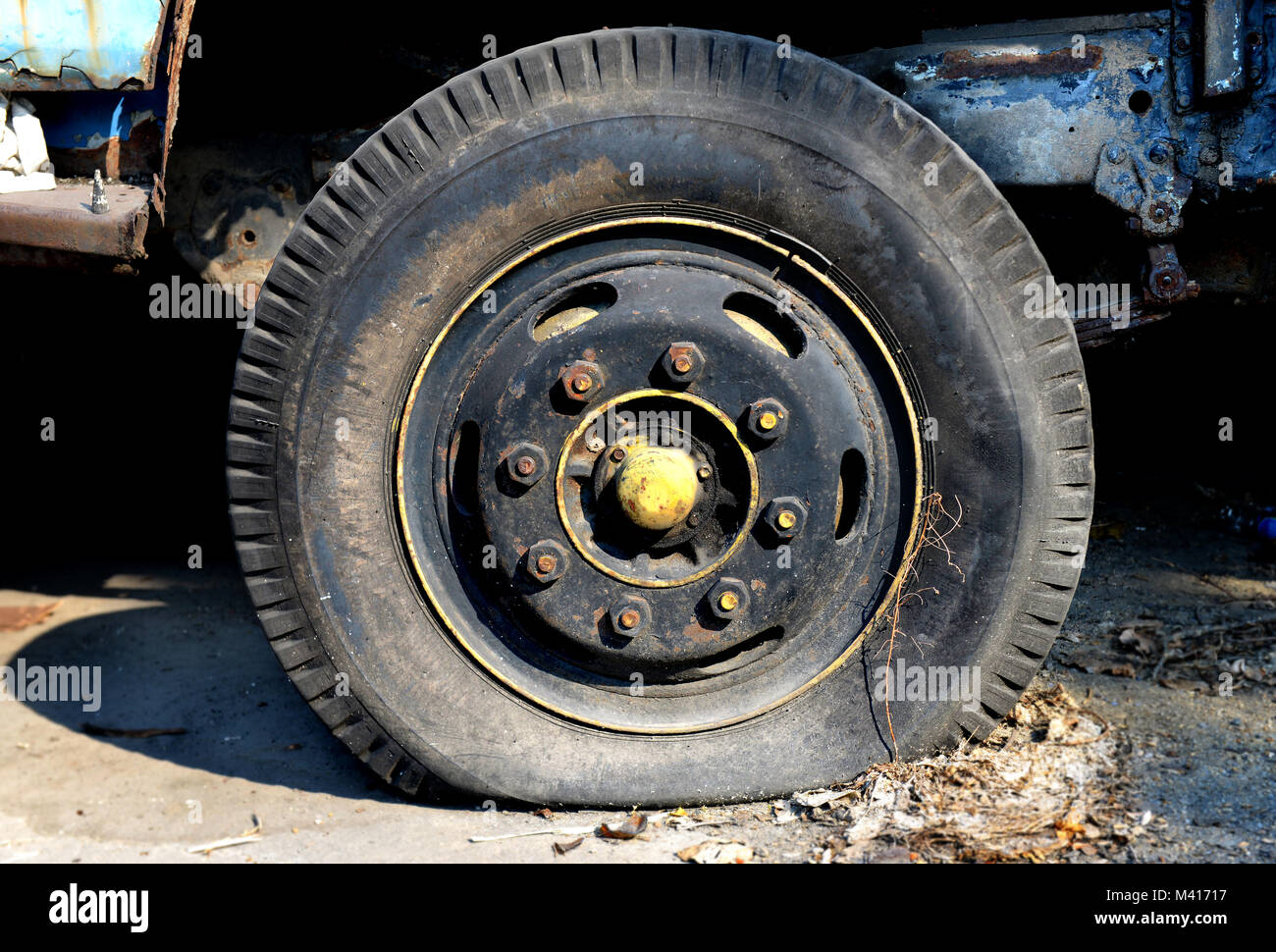 very old Flat tire car parking Stock Photo