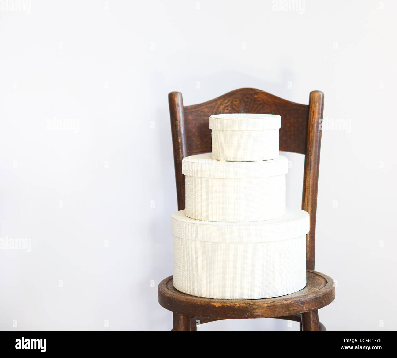 Three white boxes on a chair with copy space Stock Photo Alamy